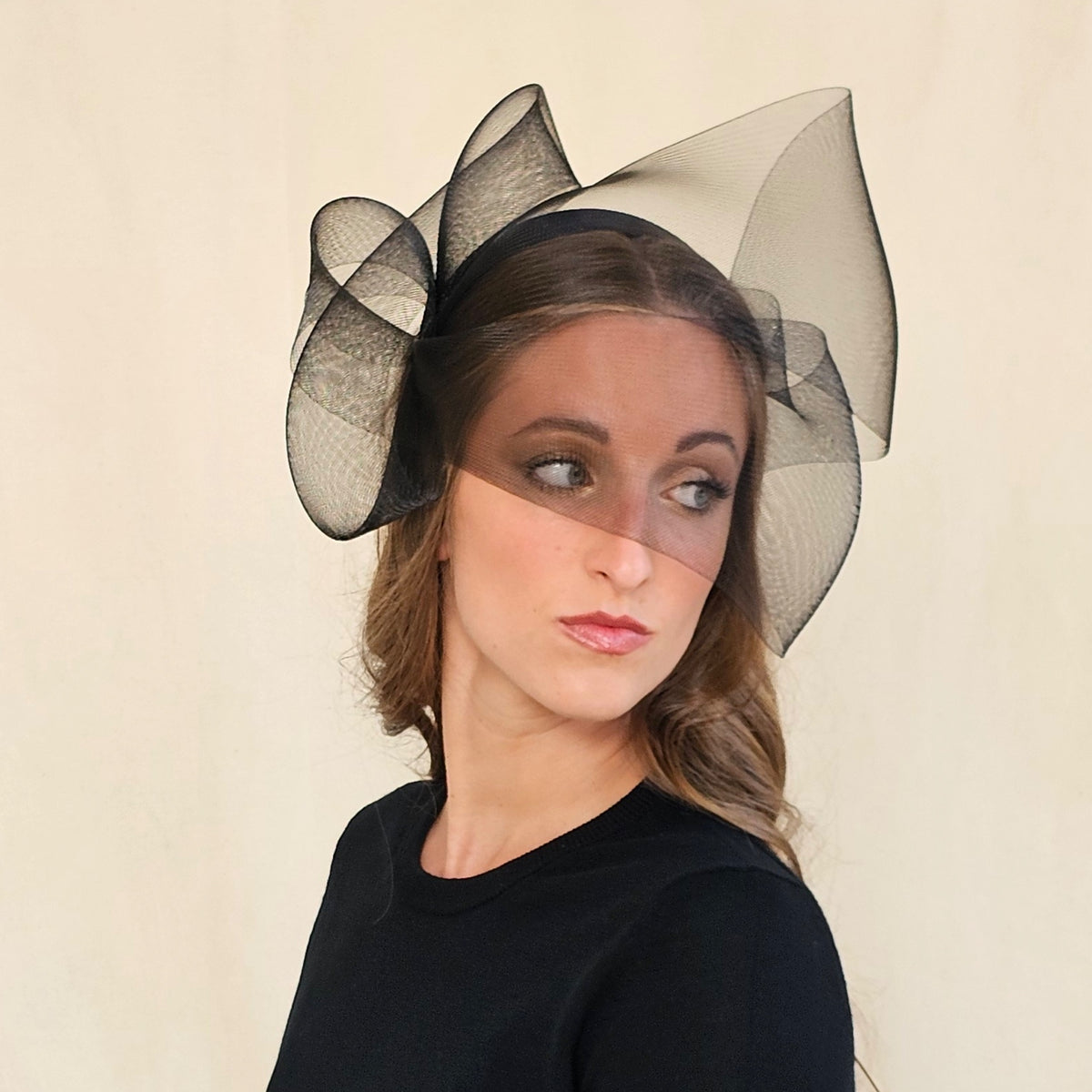 Black double-twist crin bow and face veil headband, worn on a
model.