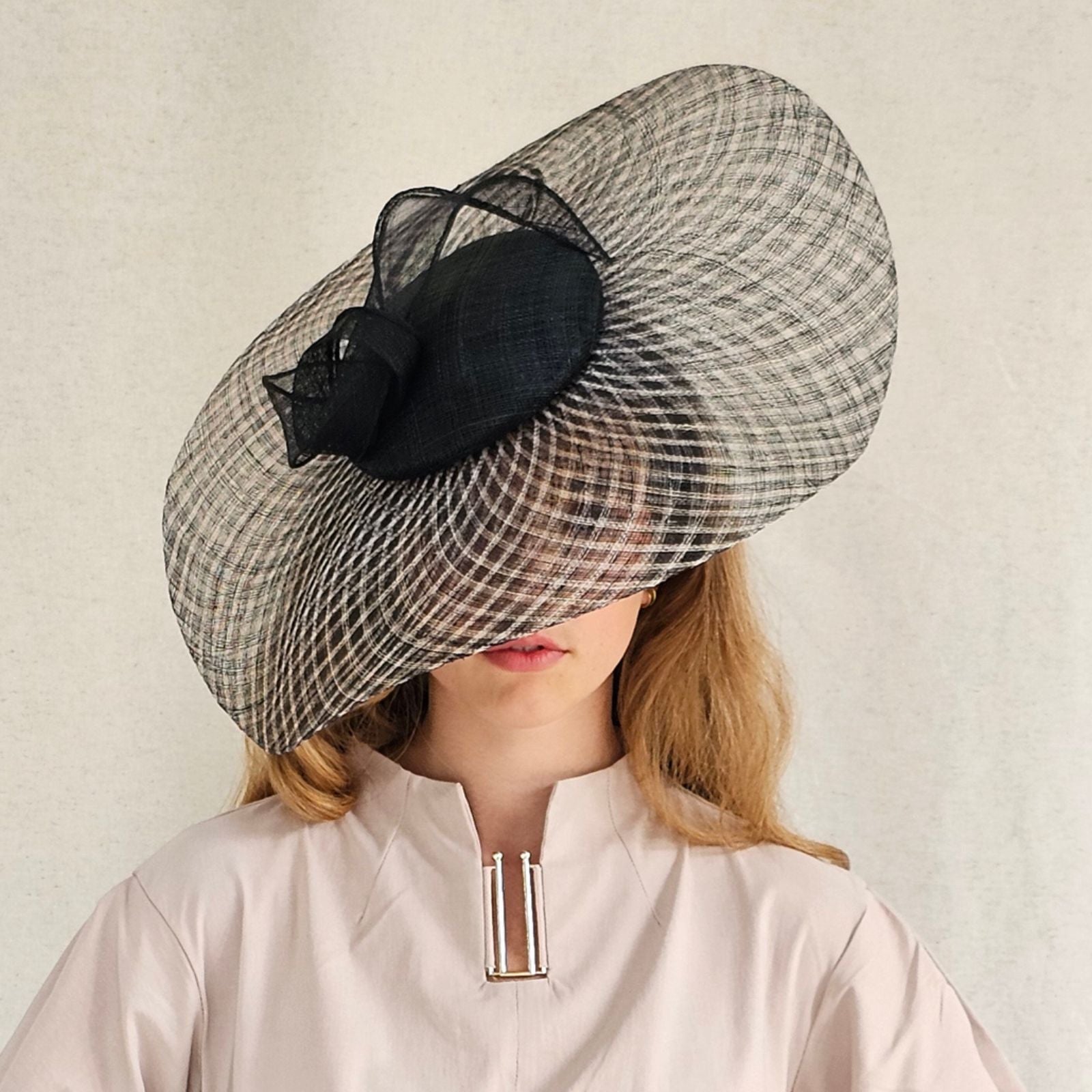 Black natural check disc hat with elegant siname knot, front view.