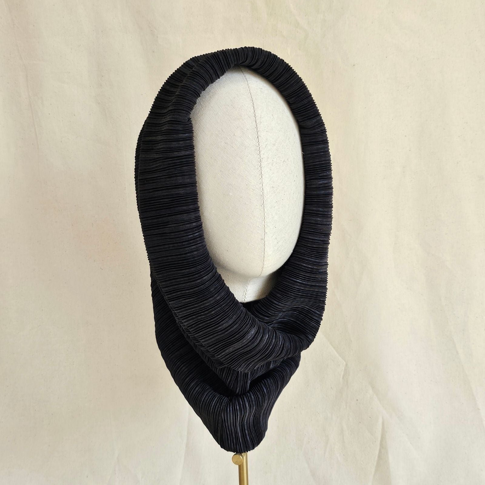 Black pleat elegant snood, front view.