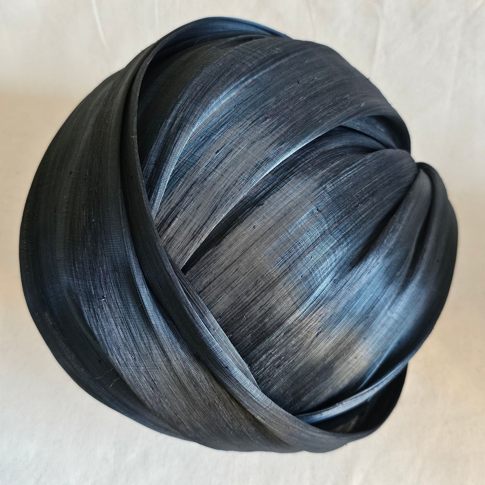 Detail of black silk abaca turban hat with beautiful sheen.