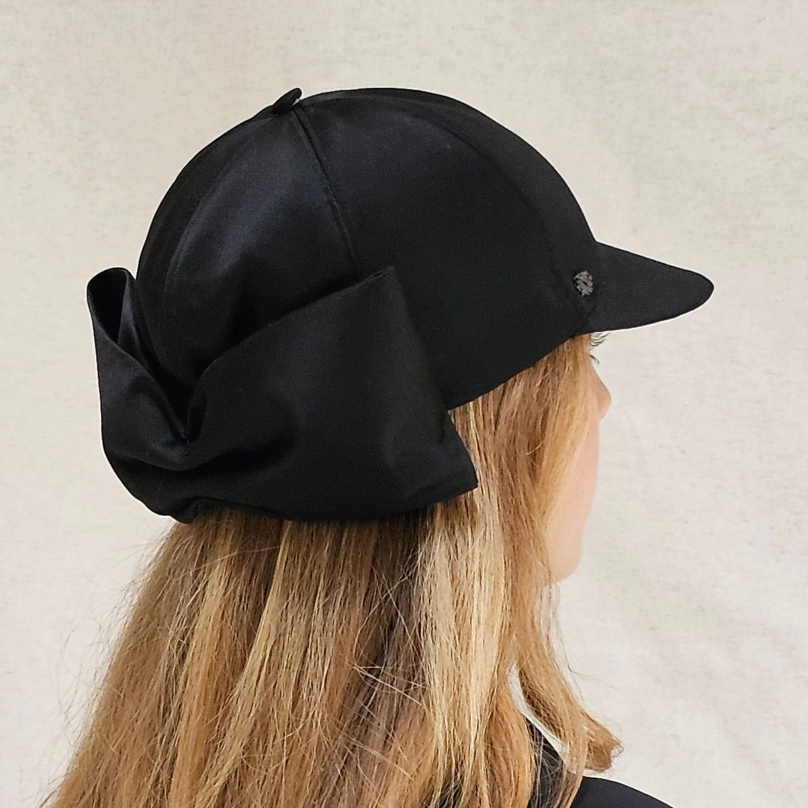Black silk baseball cap with dramatic bow, right back view.