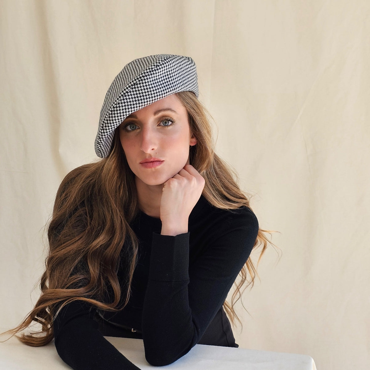 Black and white wool houndstooth tam o'shanter, worn tilted on a
model.