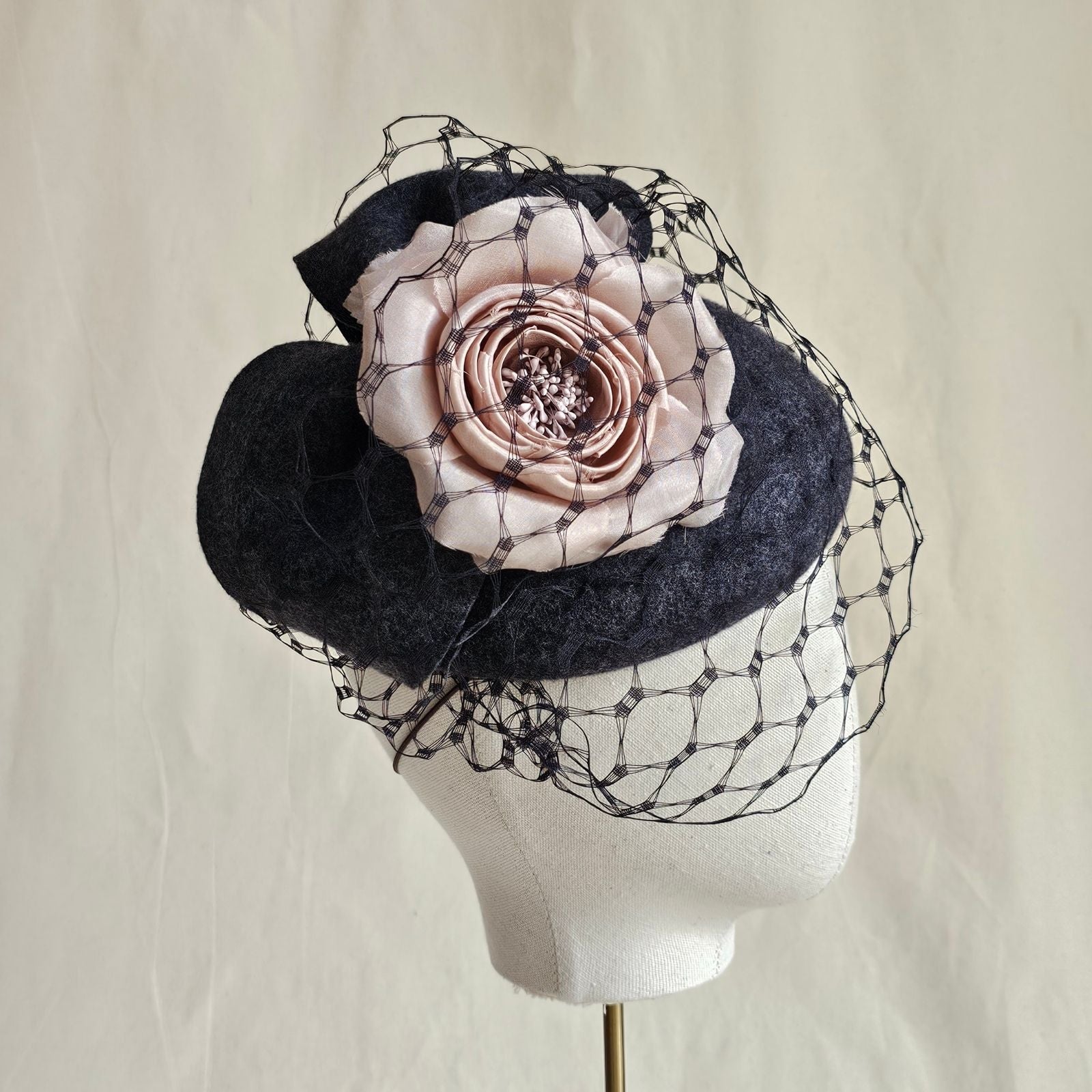 Charcoal felt beret with beautiful pink rose and veiling, side view.