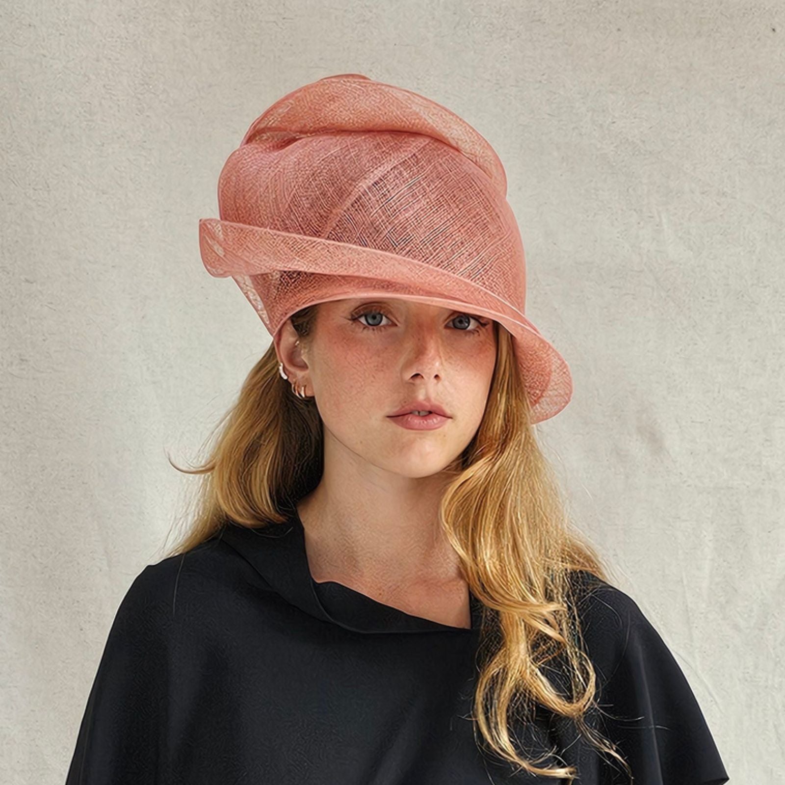 Coral sinamay cloche turban hat, front view.