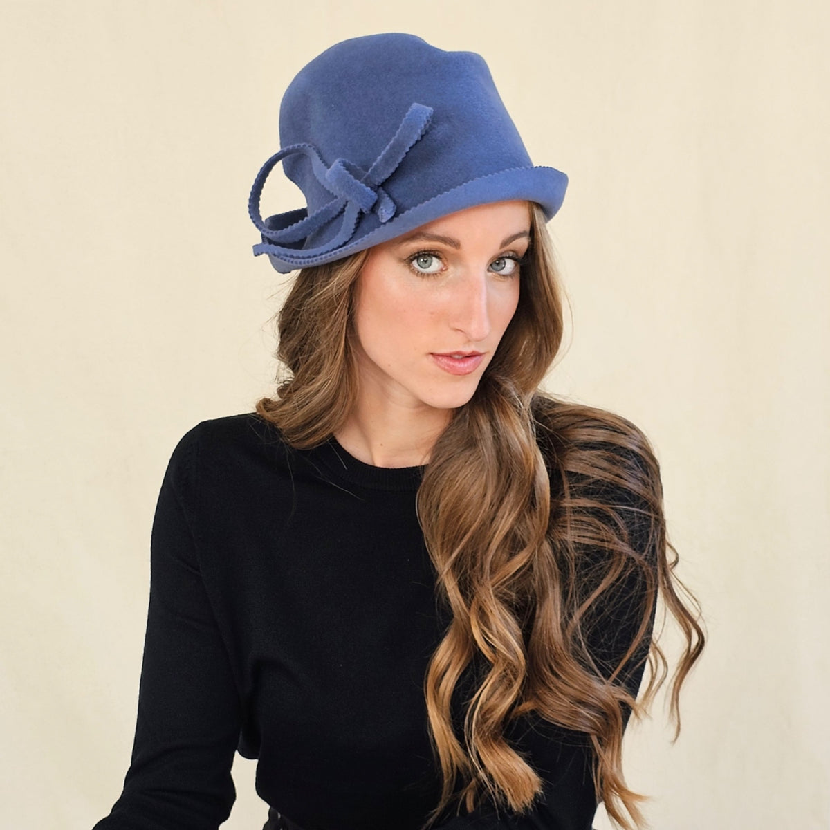 Cornflower blue felt trilby with raw zigzag edges and a loop bow.