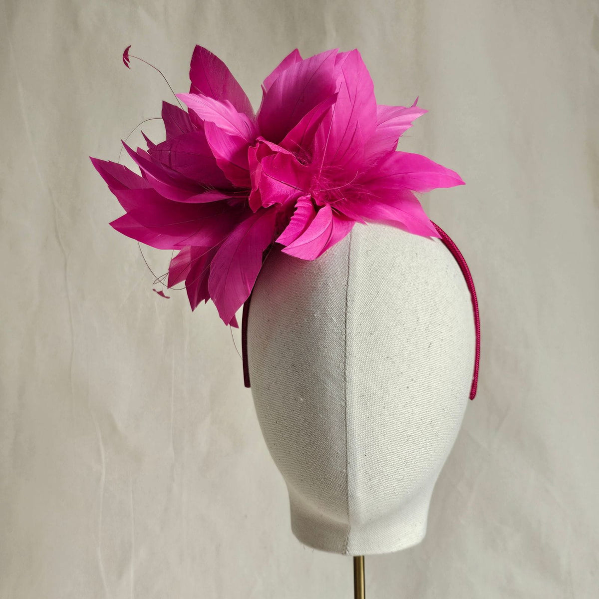 Fuchsia elegant feather flower fascinator, front view.