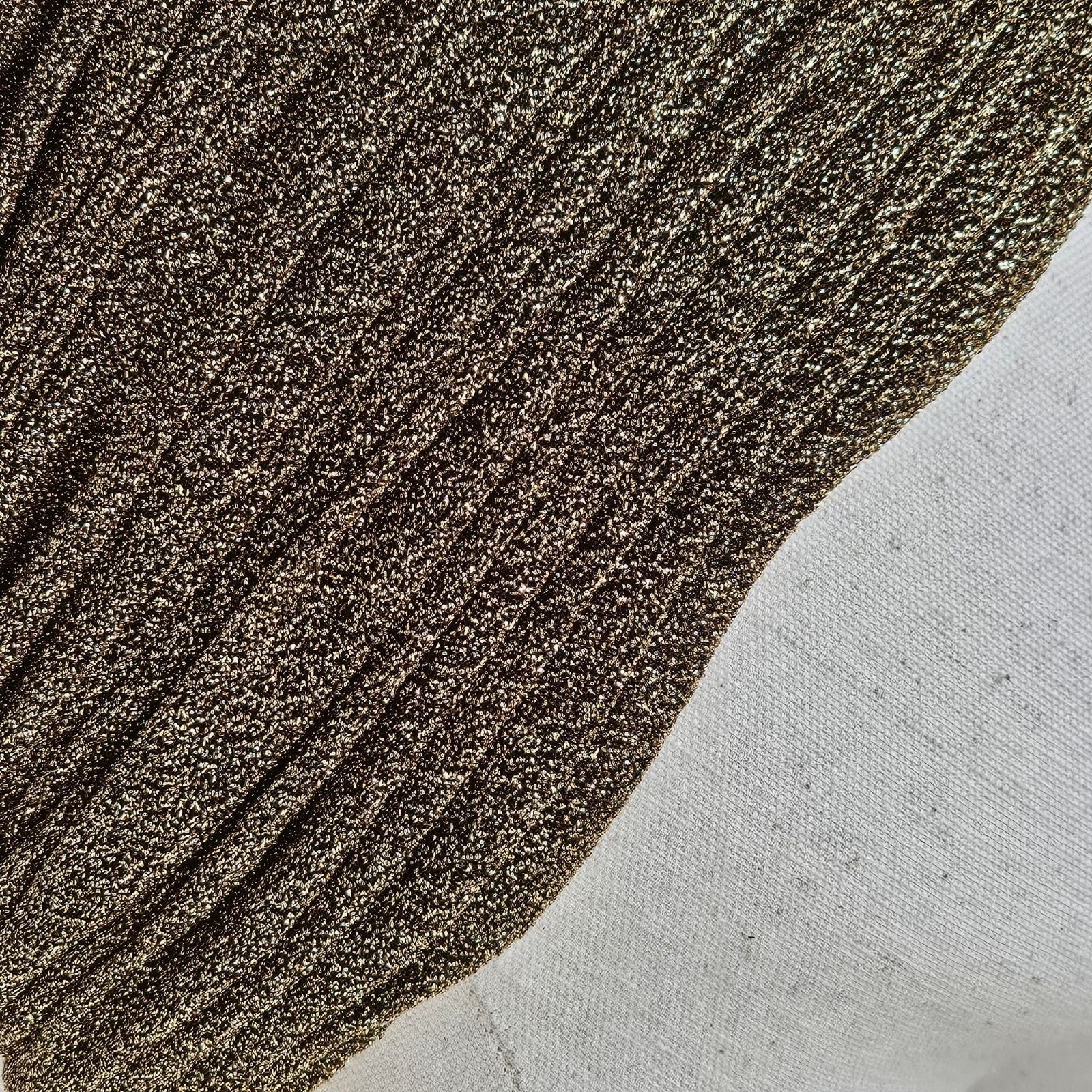 Detail of gold lurex gathered turban.