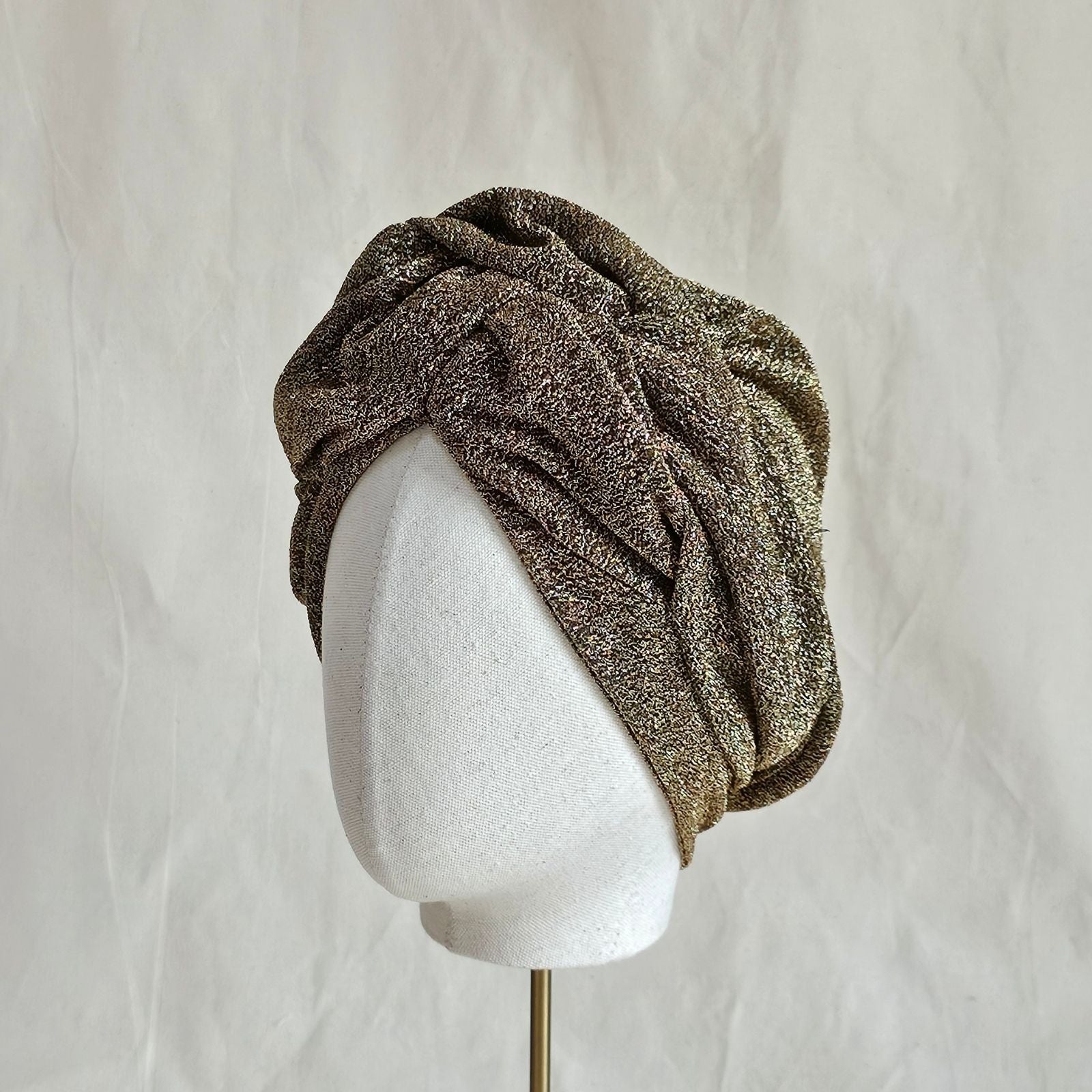 Gold lurex turban with beautiful gathered shaping, left view.