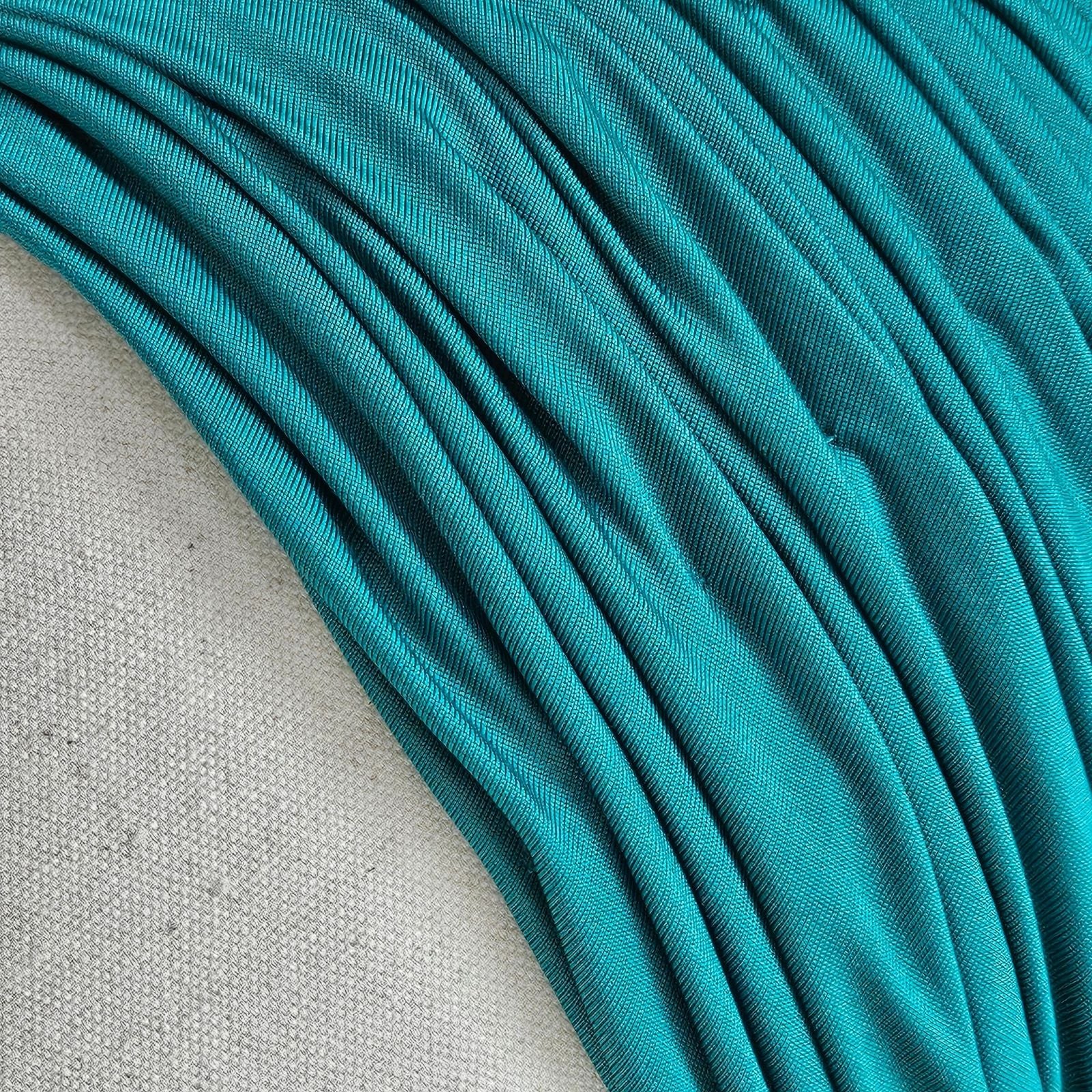 Detail of green silk jersey gathered turban.