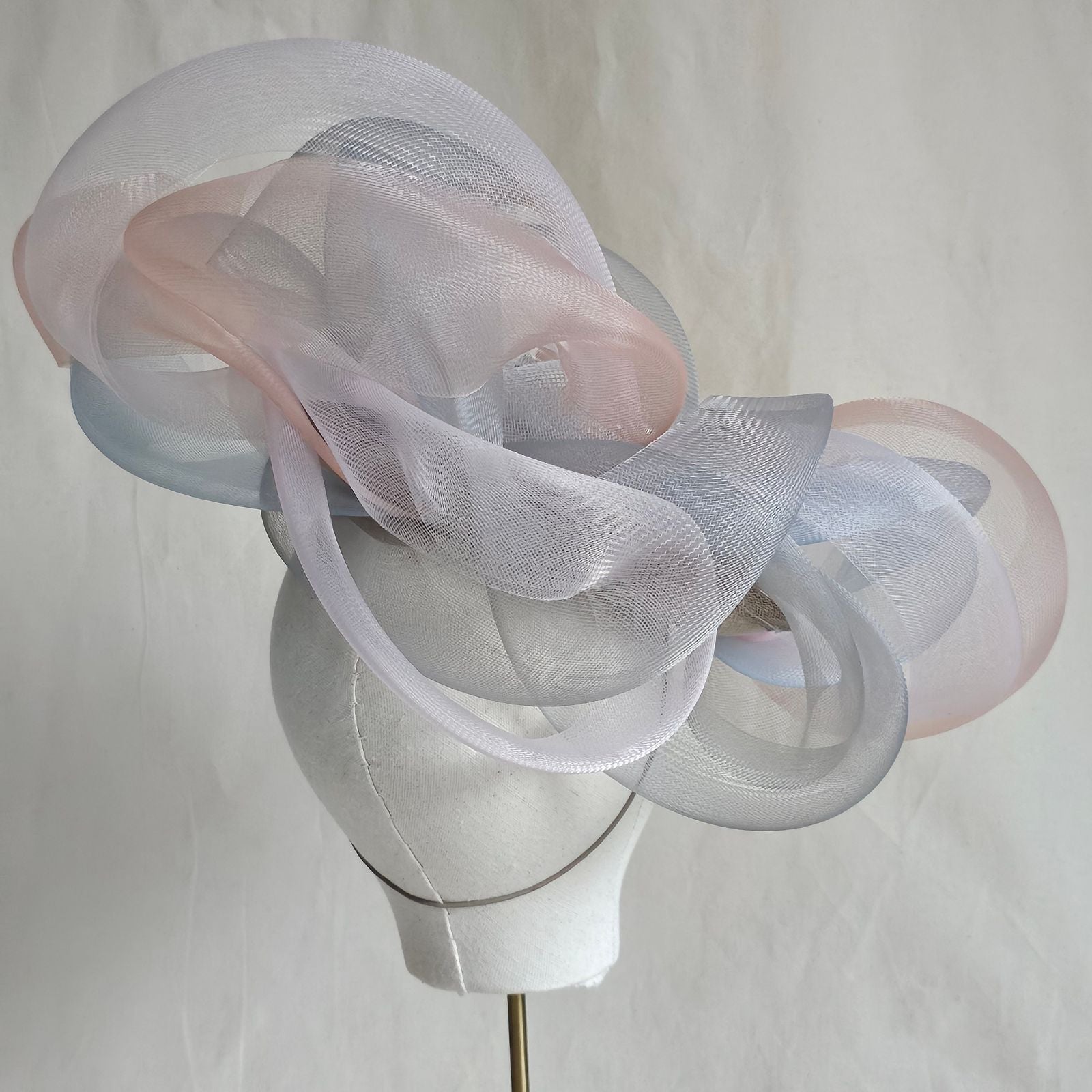 Grey, blue and pink crin swirl ascot hat with crystal diamanté globe embellishment, rear view.