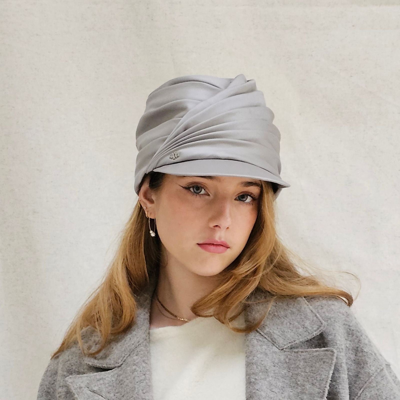 Grey cotton gathered turban peak, front view.
