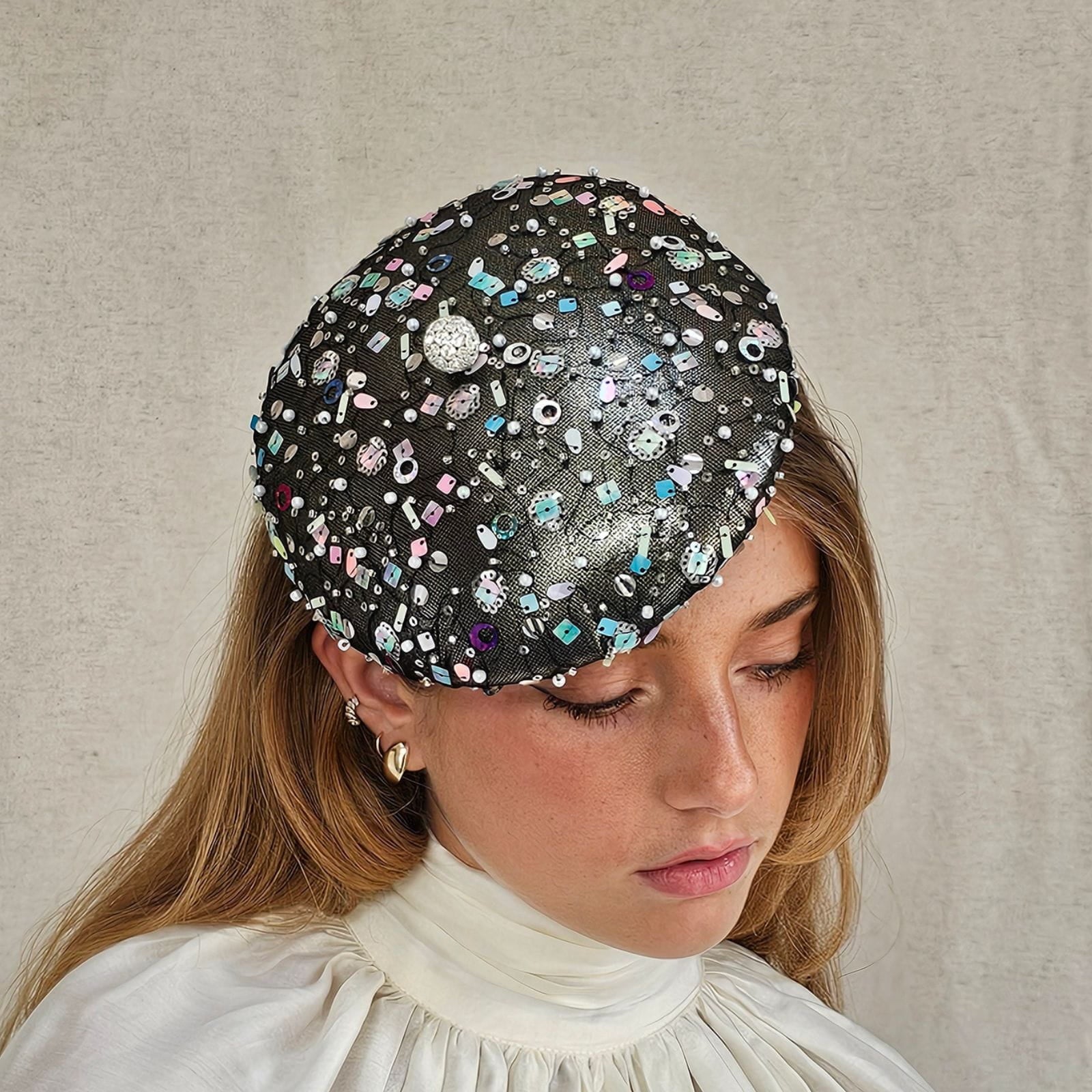 Gunmetal lamé beret with multicolour tulle sequining and crystal diamanté globe embellishment, side view.