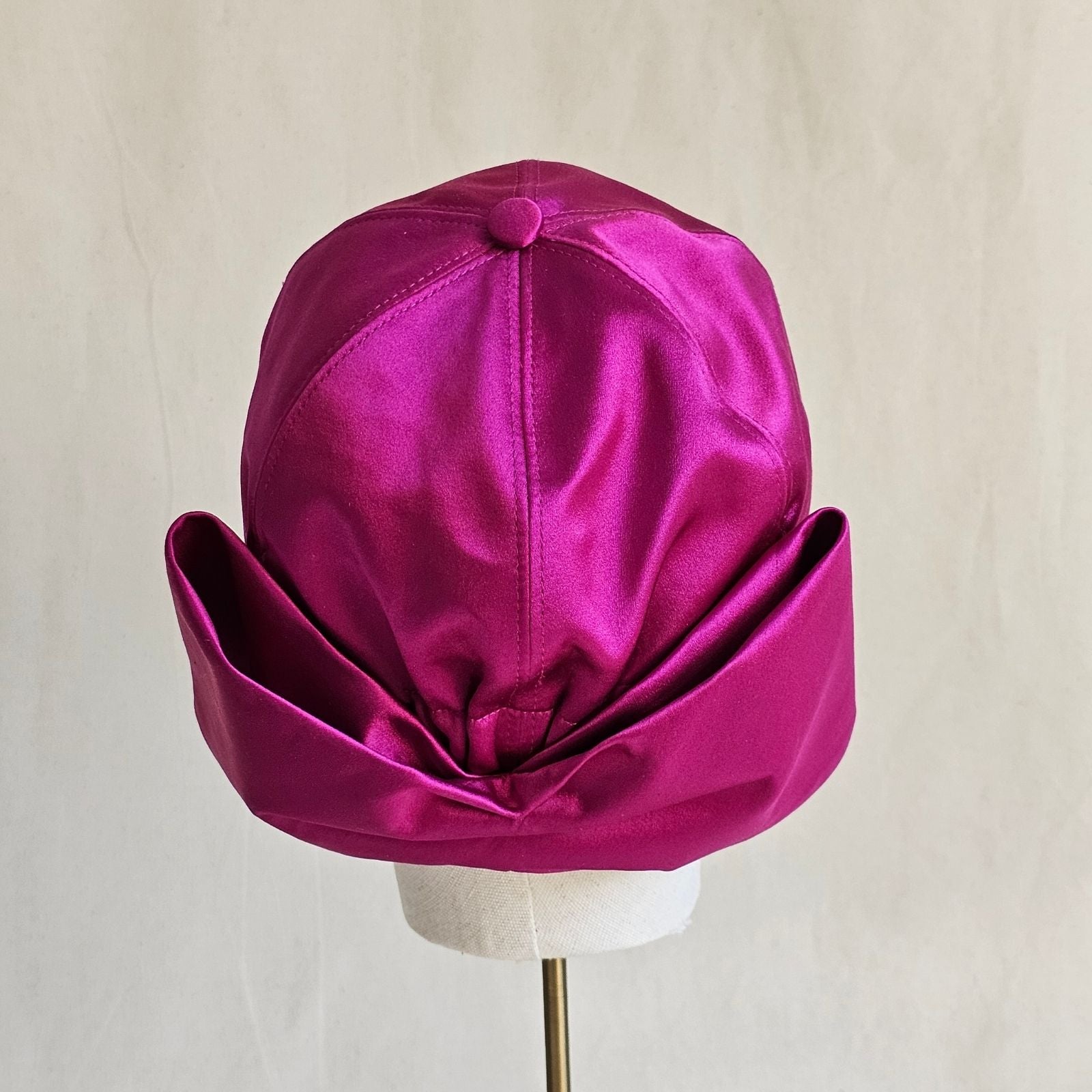 Hot pink silk basebal cap with dramatic bow, rear view.