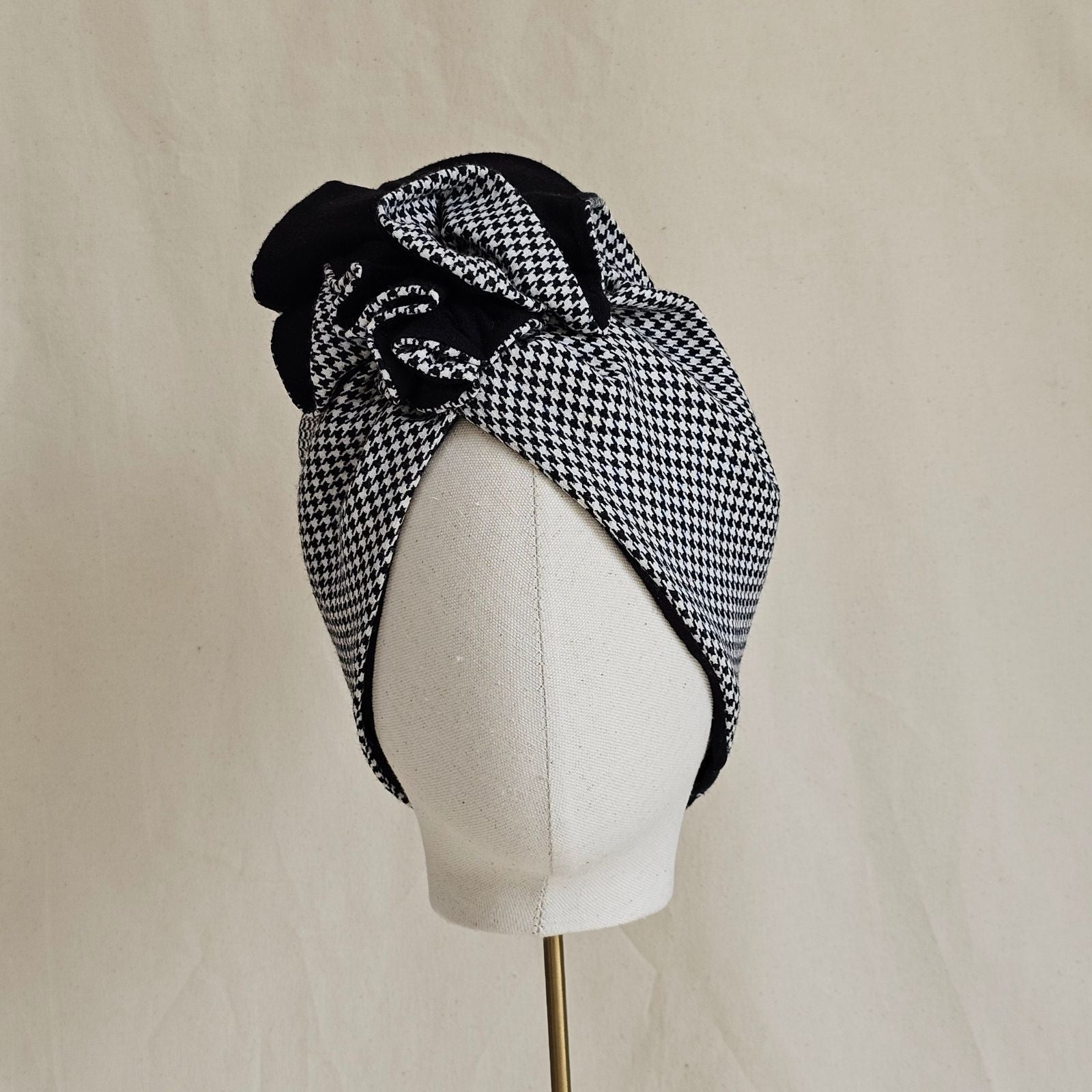 Houndstooth turban with elegant black ruffle, front view.