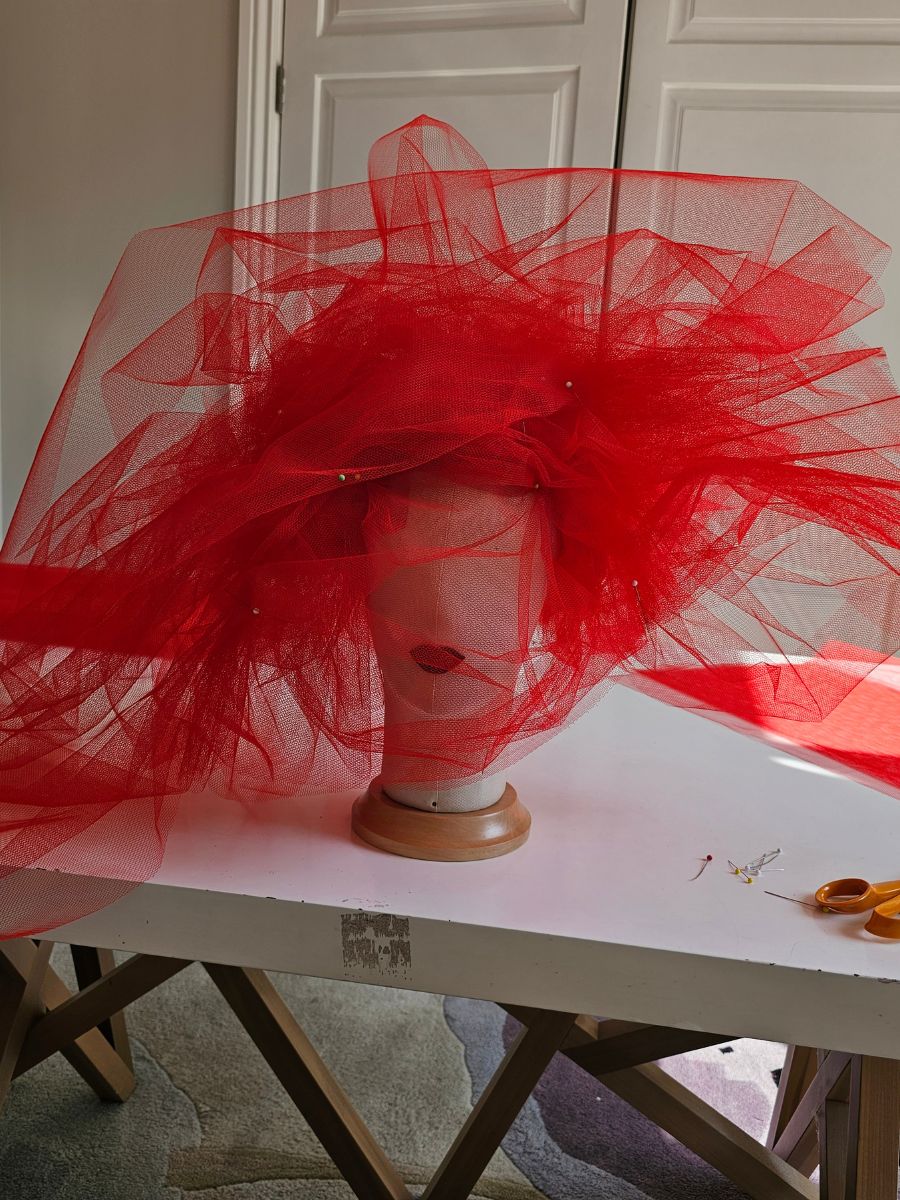 Red tulle hat in progress in the Nerida Fraiman London studio for Hunter Boots x Wuthering Heights.