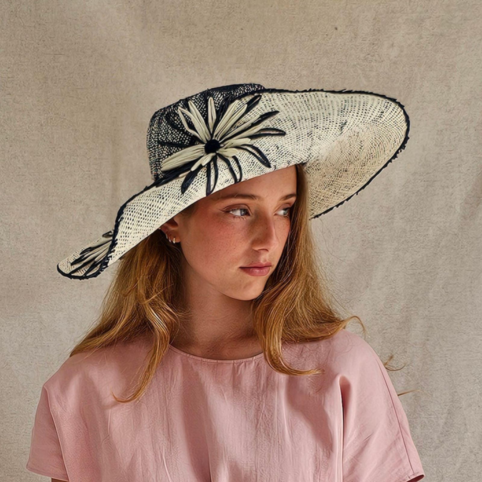 Ivory and blue straw sunhat with beautiful flower embellishments, side view.