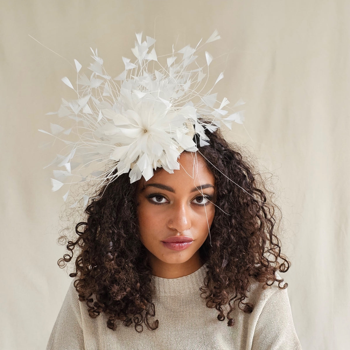 Ivory feather fascinator with feather flower, on model.