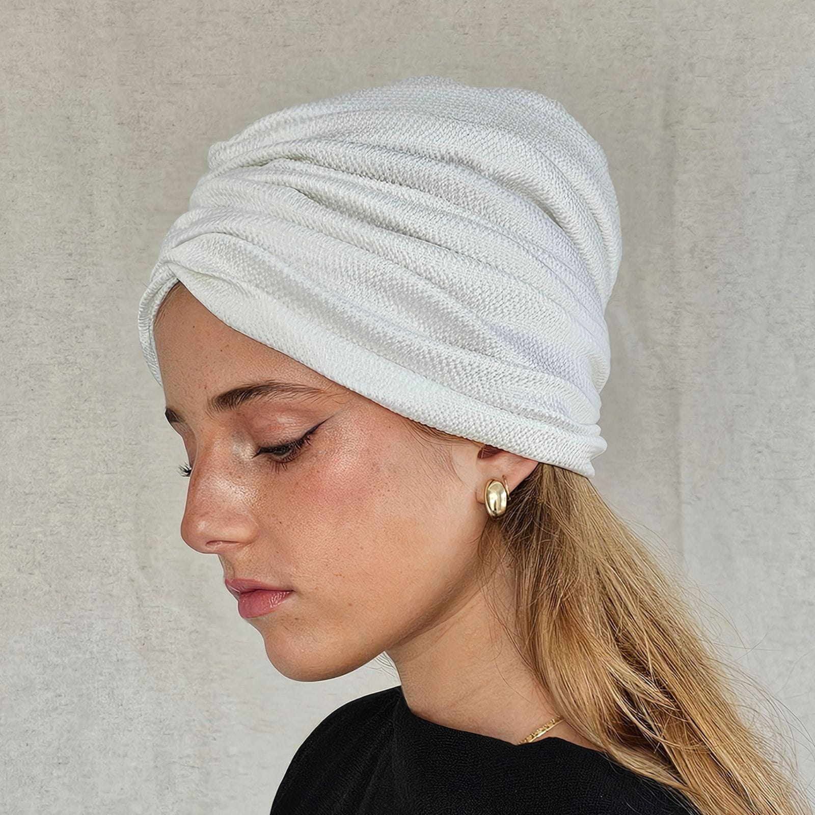 Ivory silk turban with ripple gathers, side view.