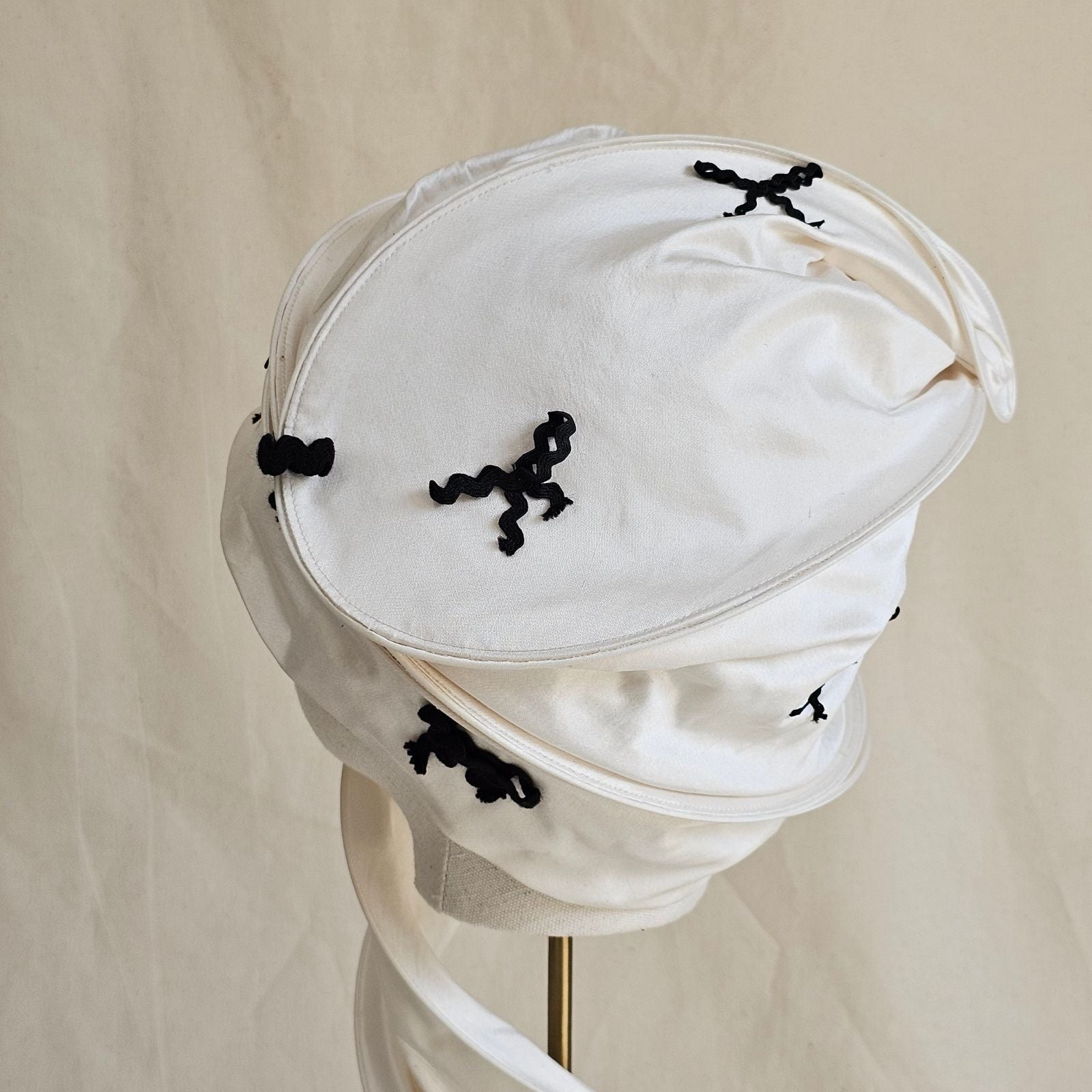 Ivory silk scarf turban with black bow detail, back view.
