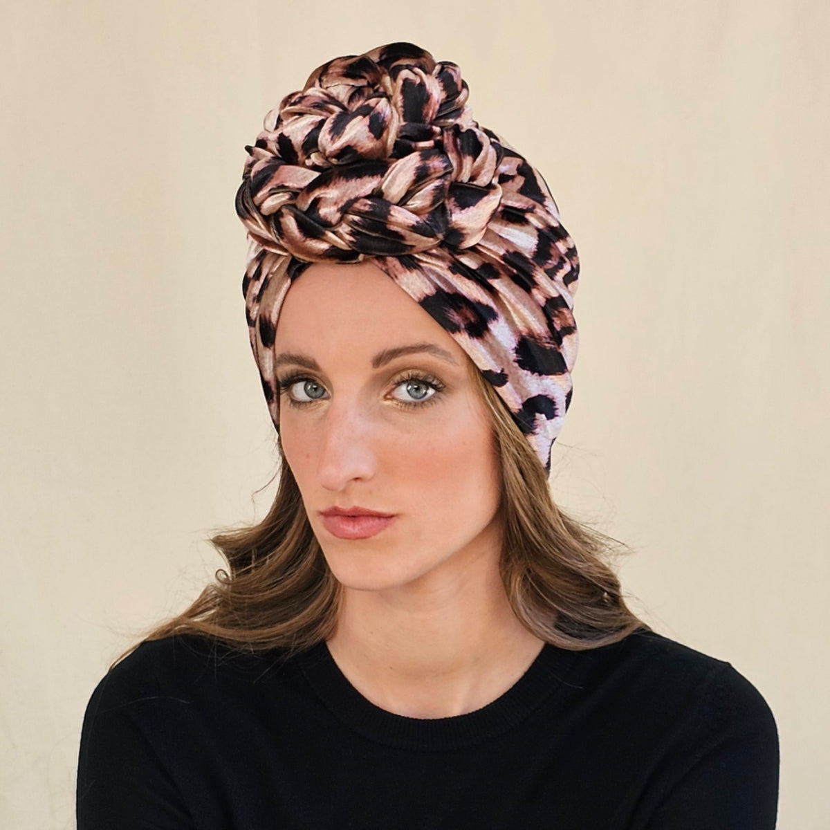 Close-up of leopard print velour turban showing sculptural braid
rose.
