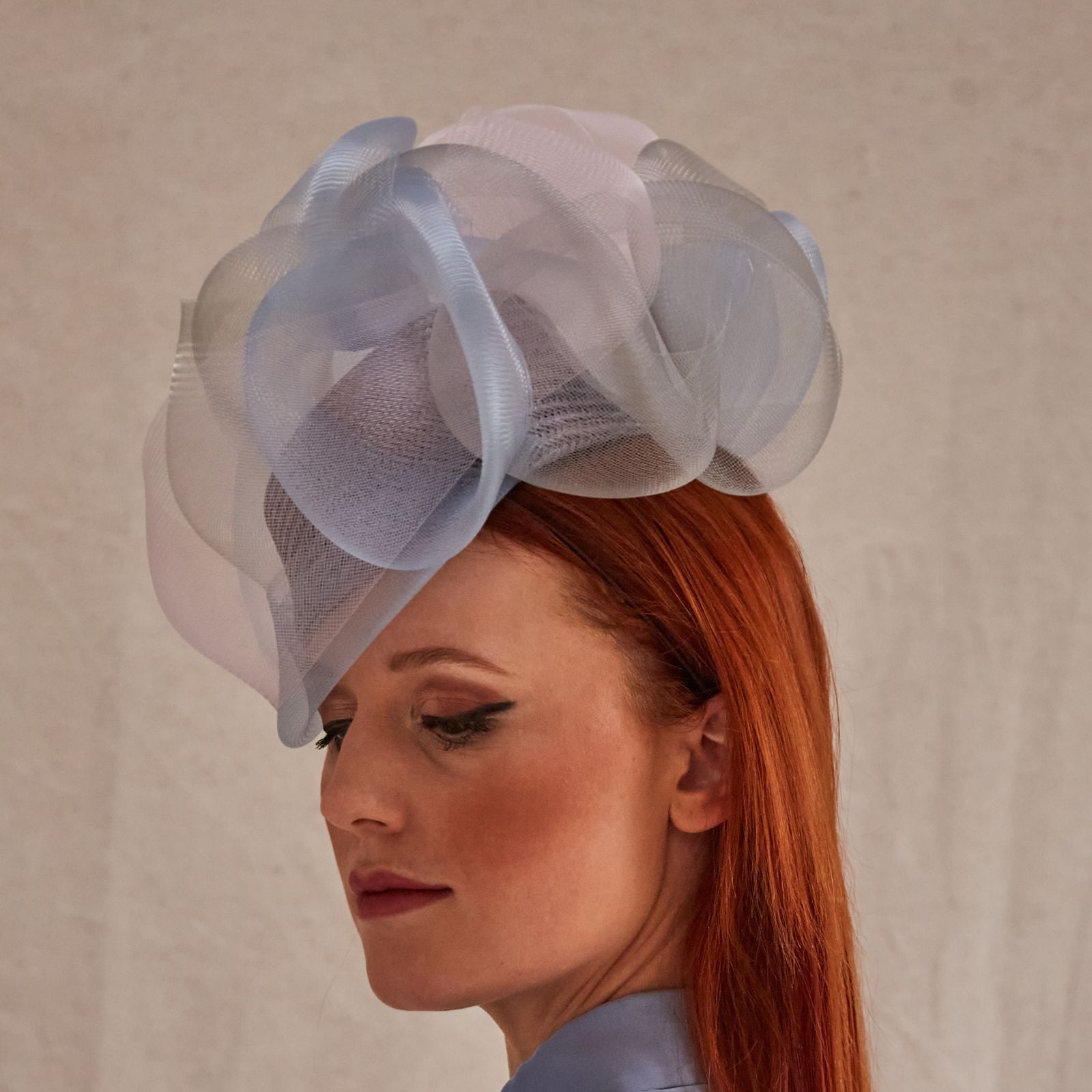 Lilac, blue and pink crin swirl pillbox hat, left view.
