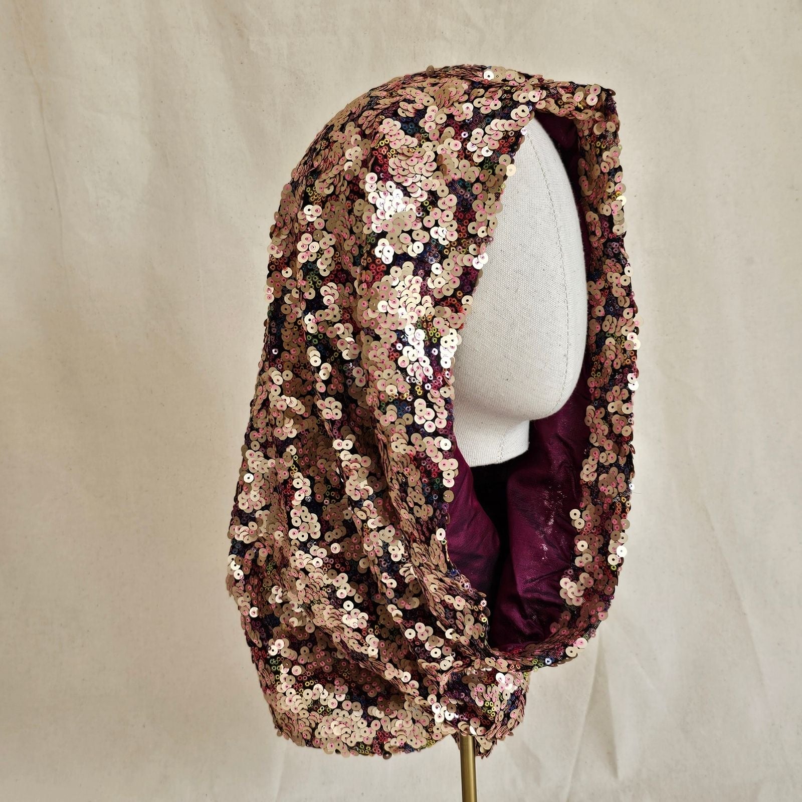 Softly sculpted multicolour designer sequin snood, angle view.