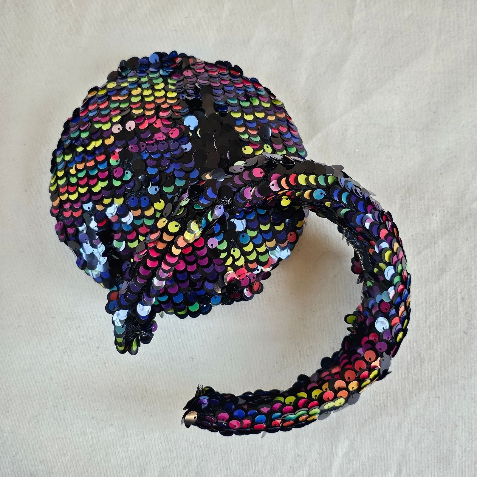 Multicoloured sequin beret and headband, top view.