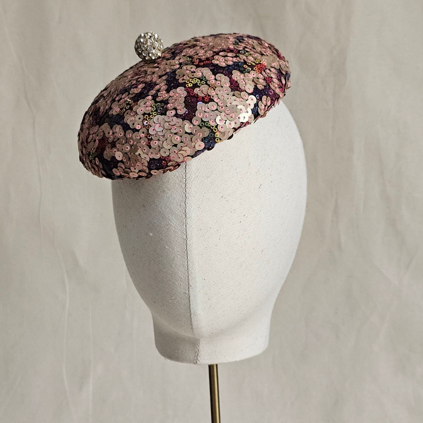 Multicolour sequin beret with crystal diamanté globe embellishment, left view.