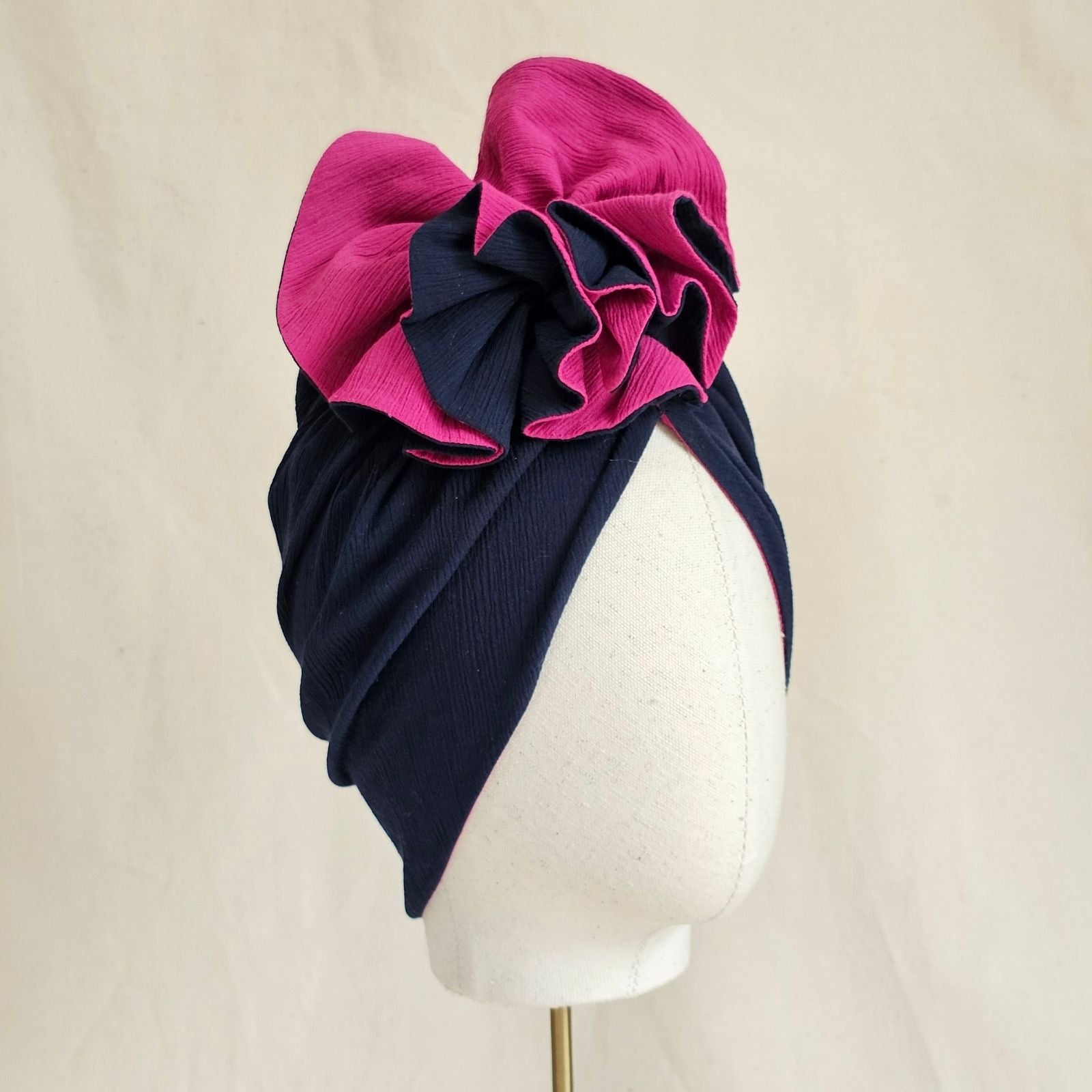 Navy and fuchsia cotton turban with intricate ruffle, side view.