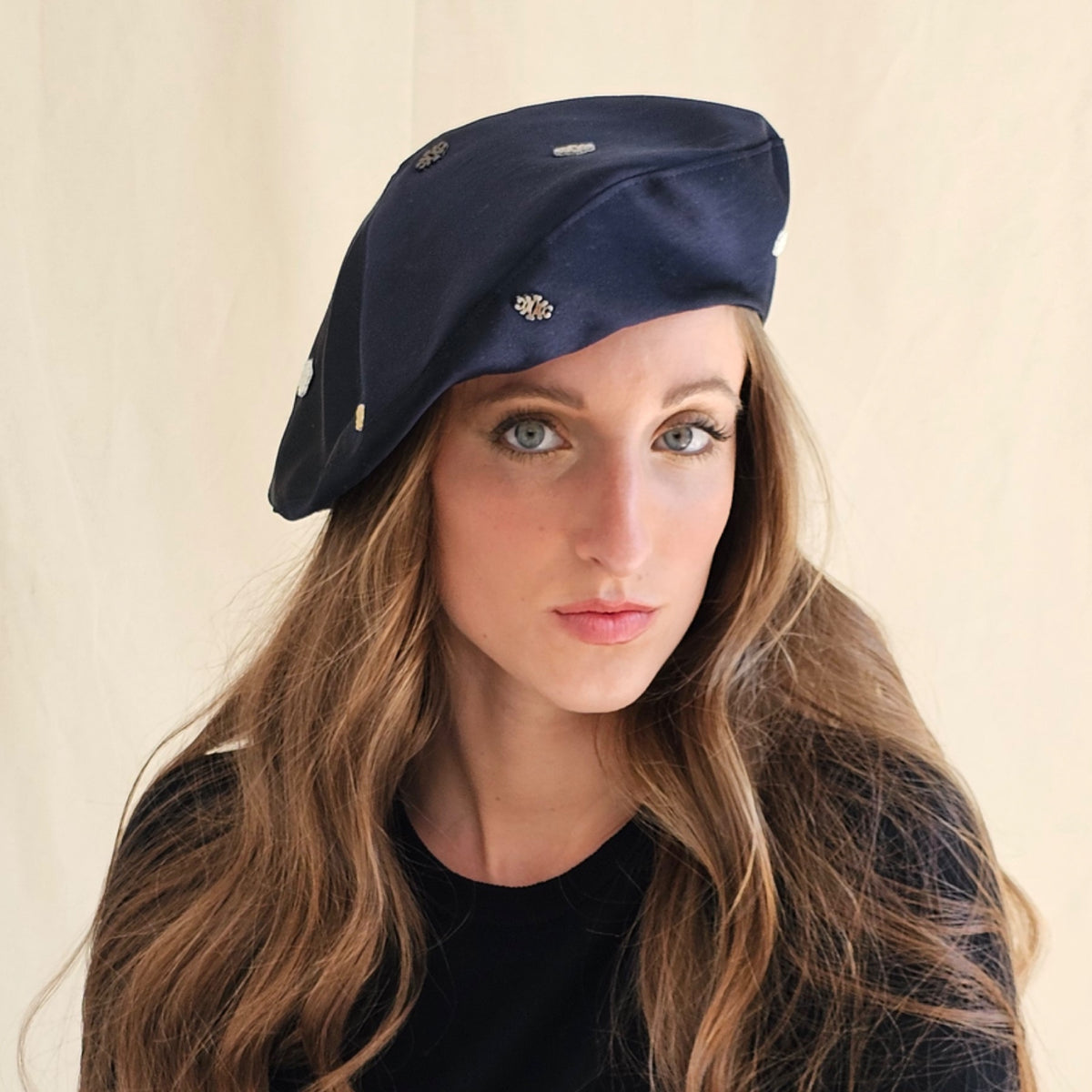 Navy silk duchesse satin tam o'shanter with small monograms,
worn on a model.