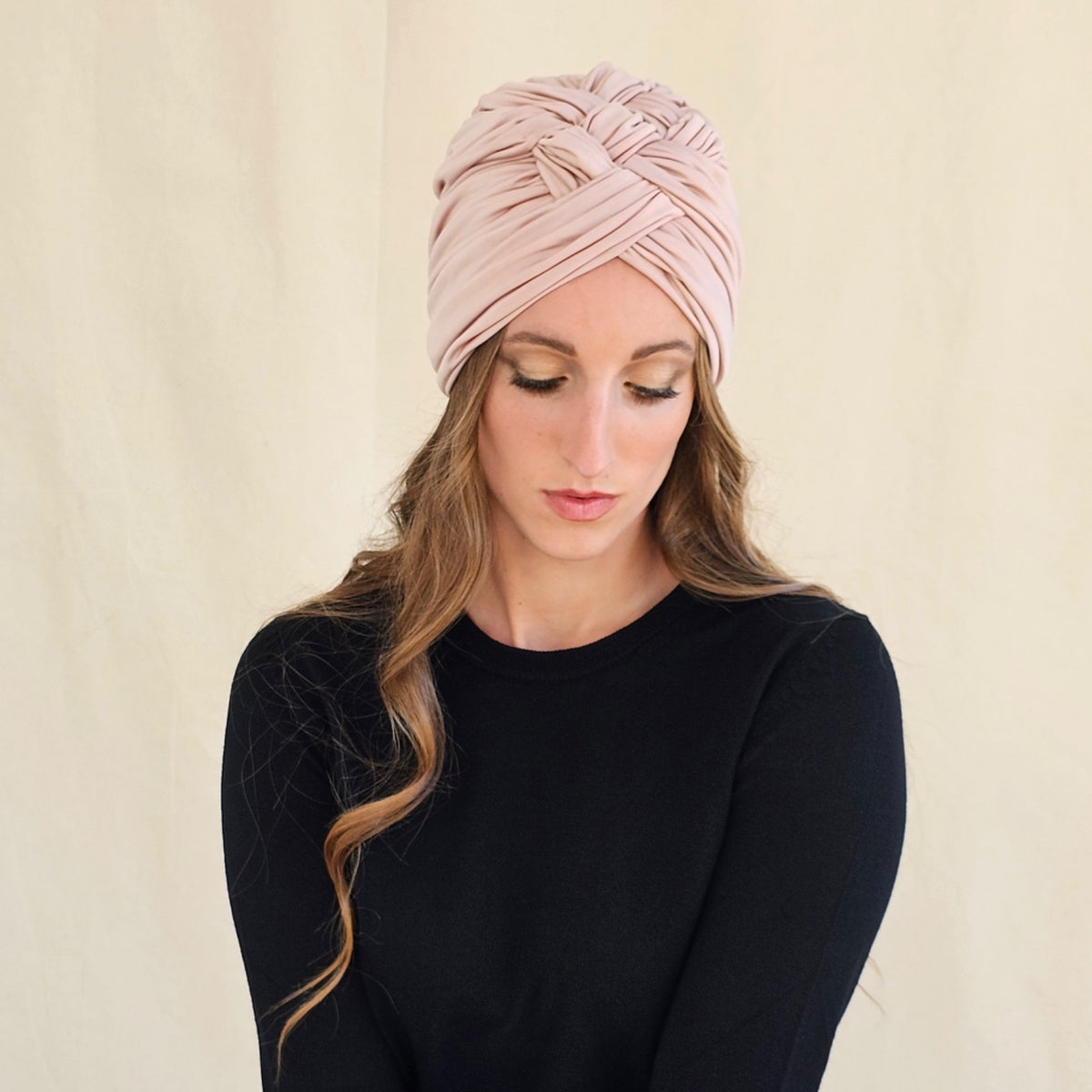 Front view of nude silk jersey turban showing crossed folds and
braiding.