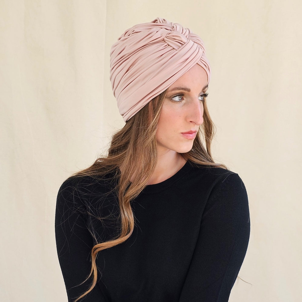 Side view of nude silk jersey turban showing gathered folds.