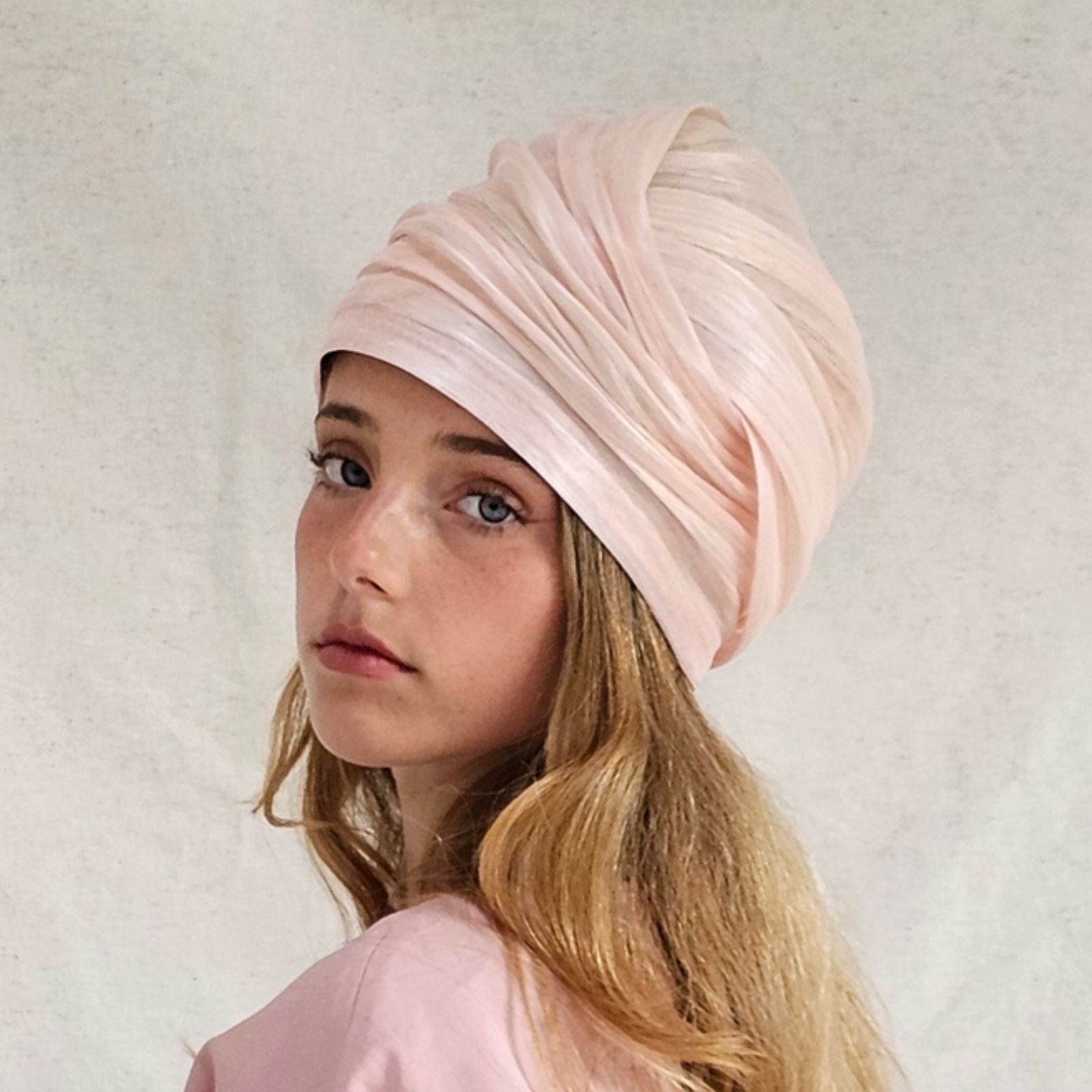 Pink silk abaca turban with beautiful sheen, angle view.