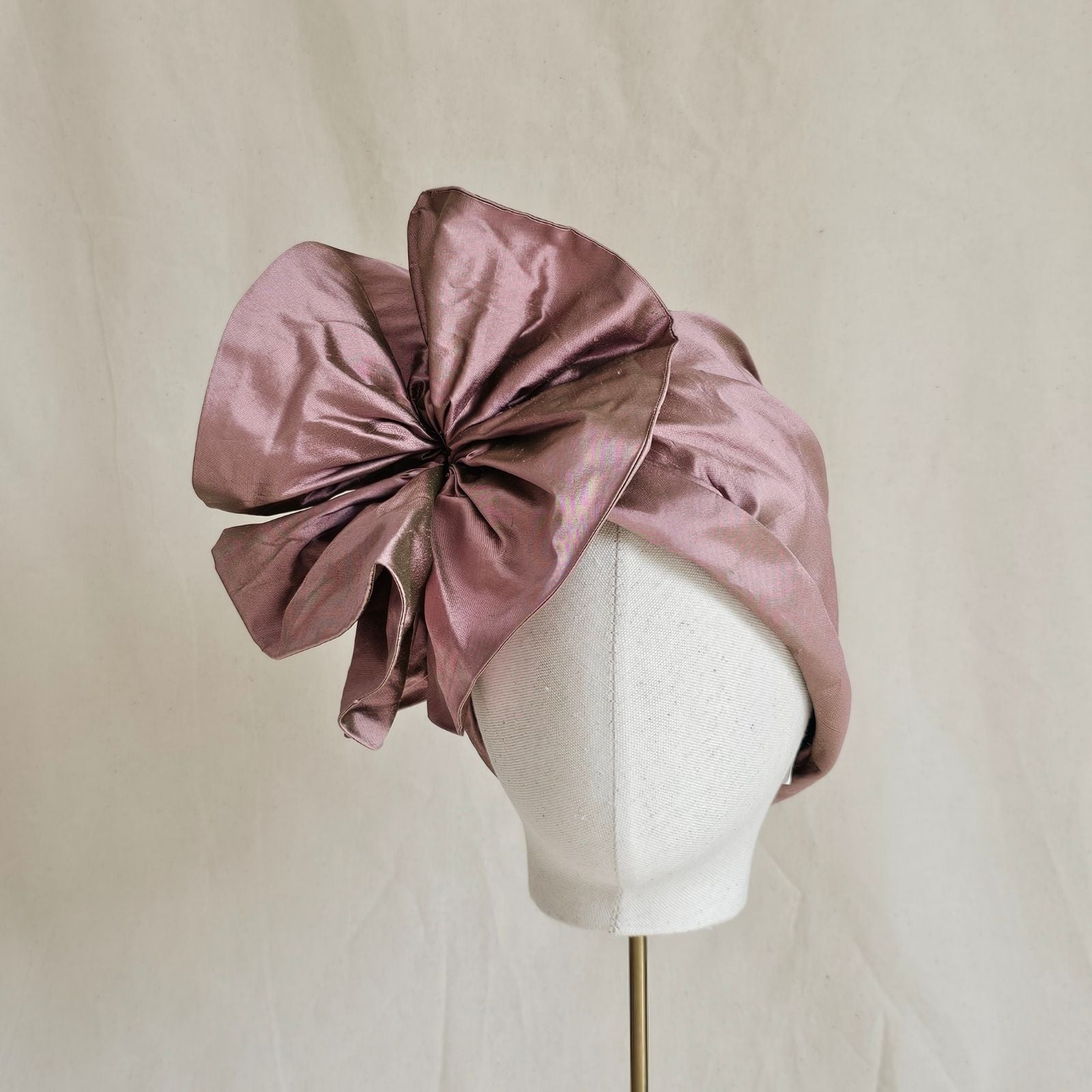 Pink silk turban with beautiful flower ruffle, front view.
