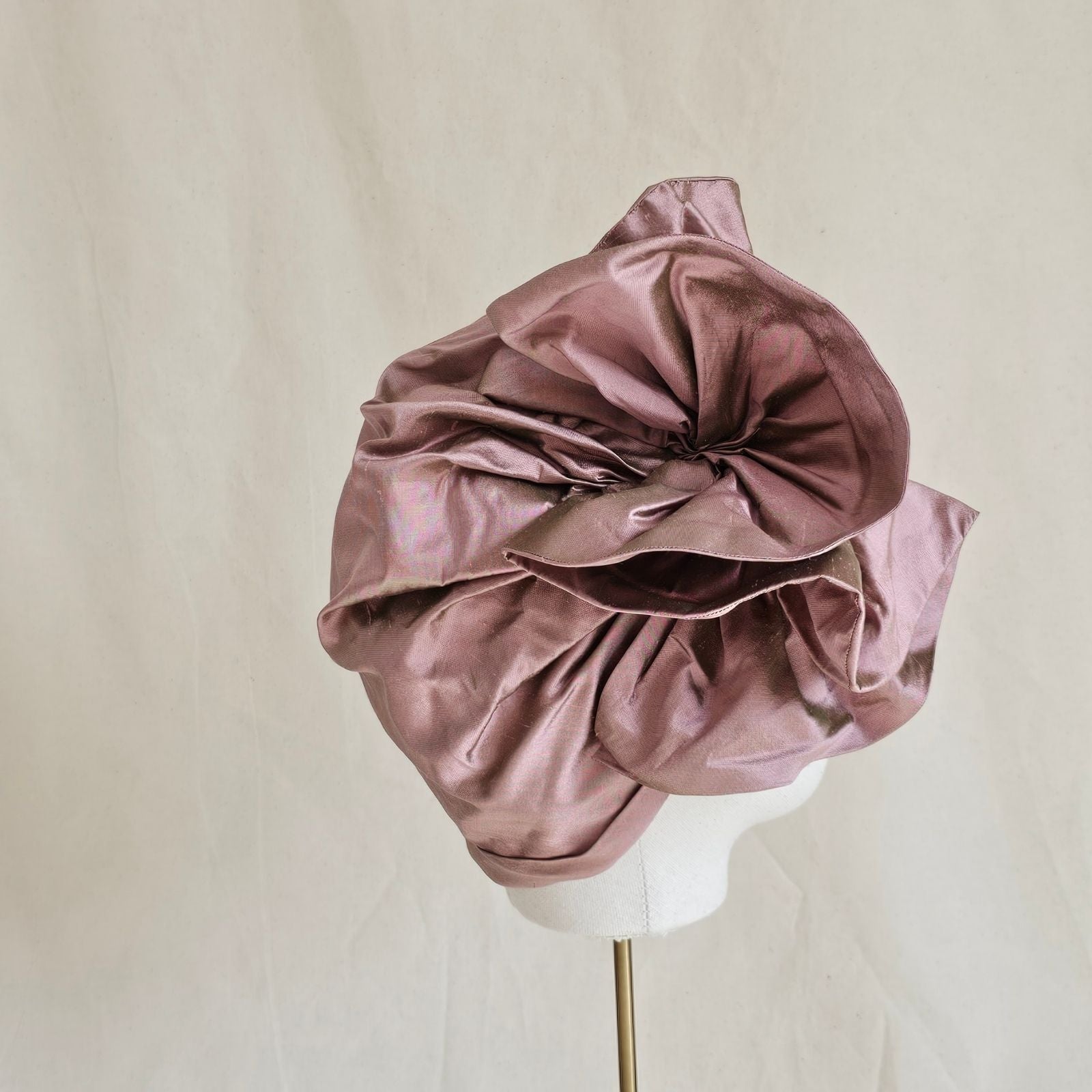 Pink silk turban with elegant ruffle, side view.
