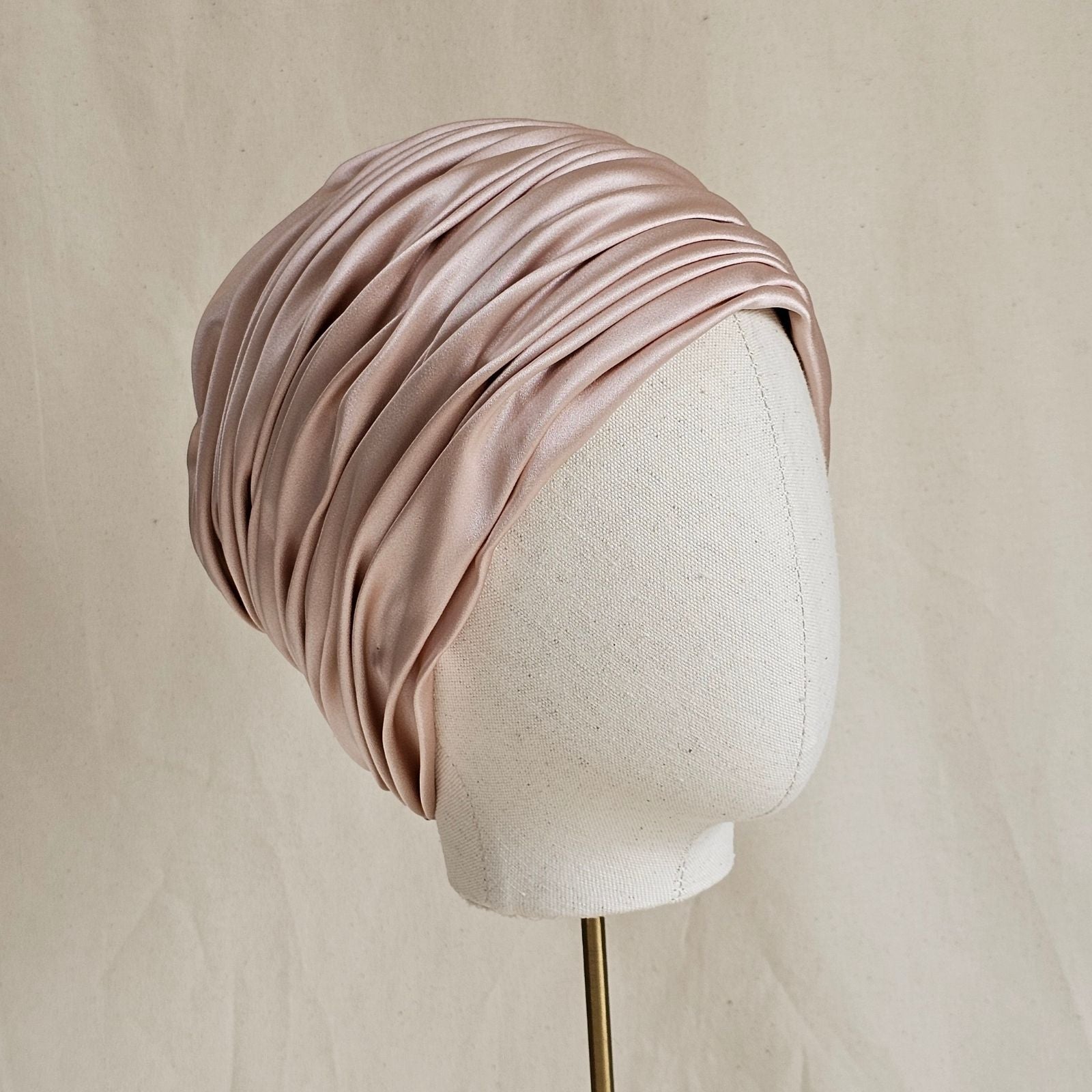 Pink silk and satin beautiful gathered turban, angle view.