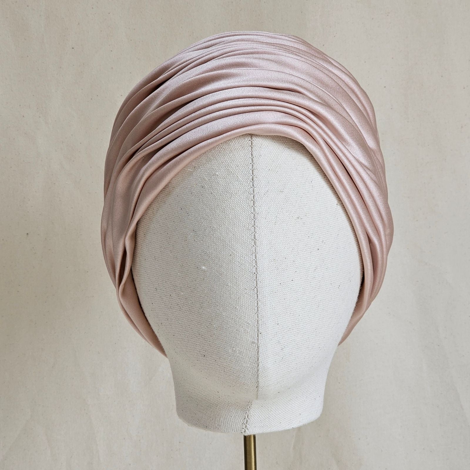 Pink silk and satin elegant gathered turban, front view.