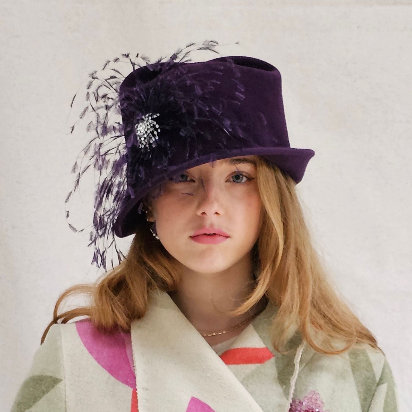 Plum felt cloche hat with beautiful crystal embellishment and feather flower.