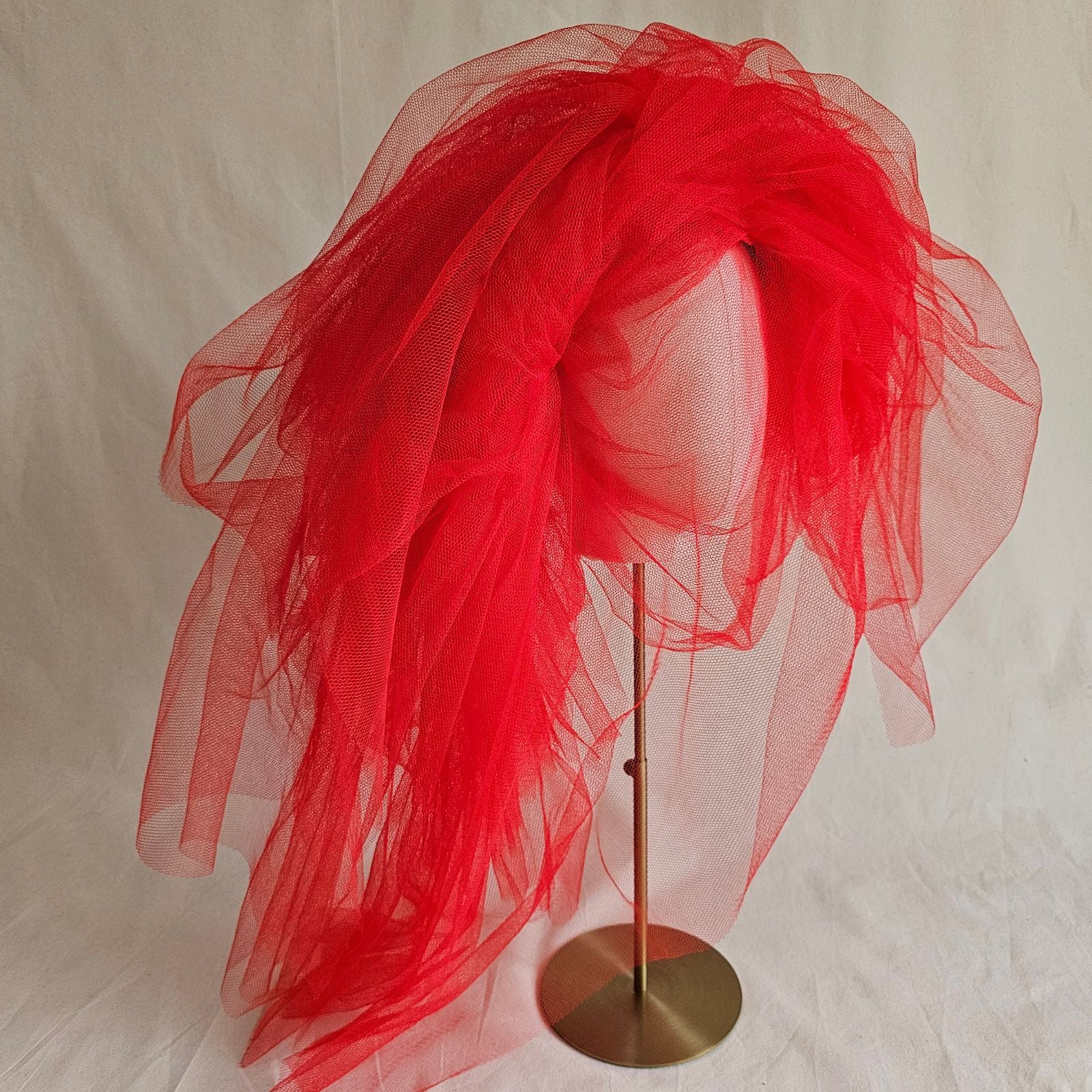 Red tulle statement hat right view.
