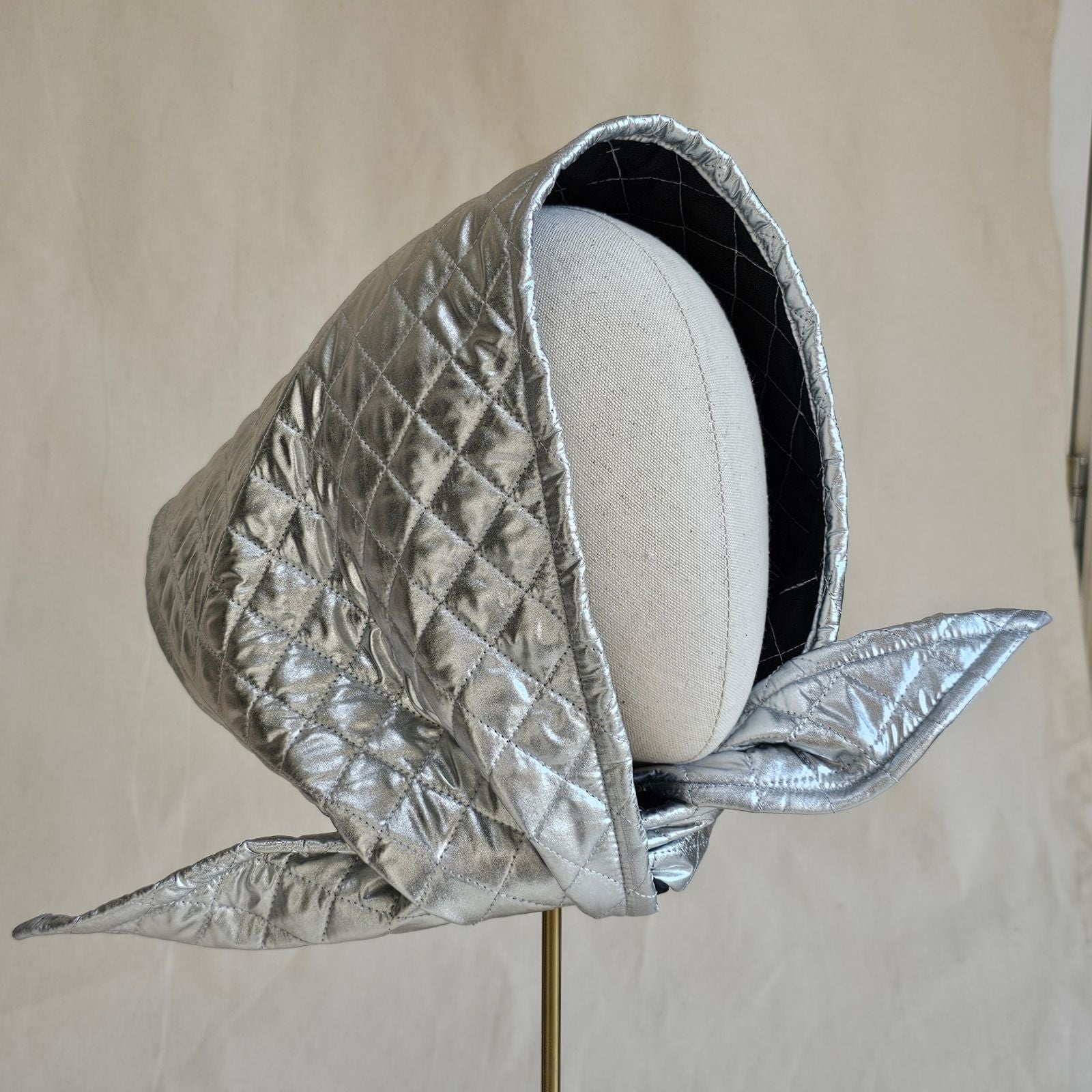 Silver quilted scarf hat, angle view.