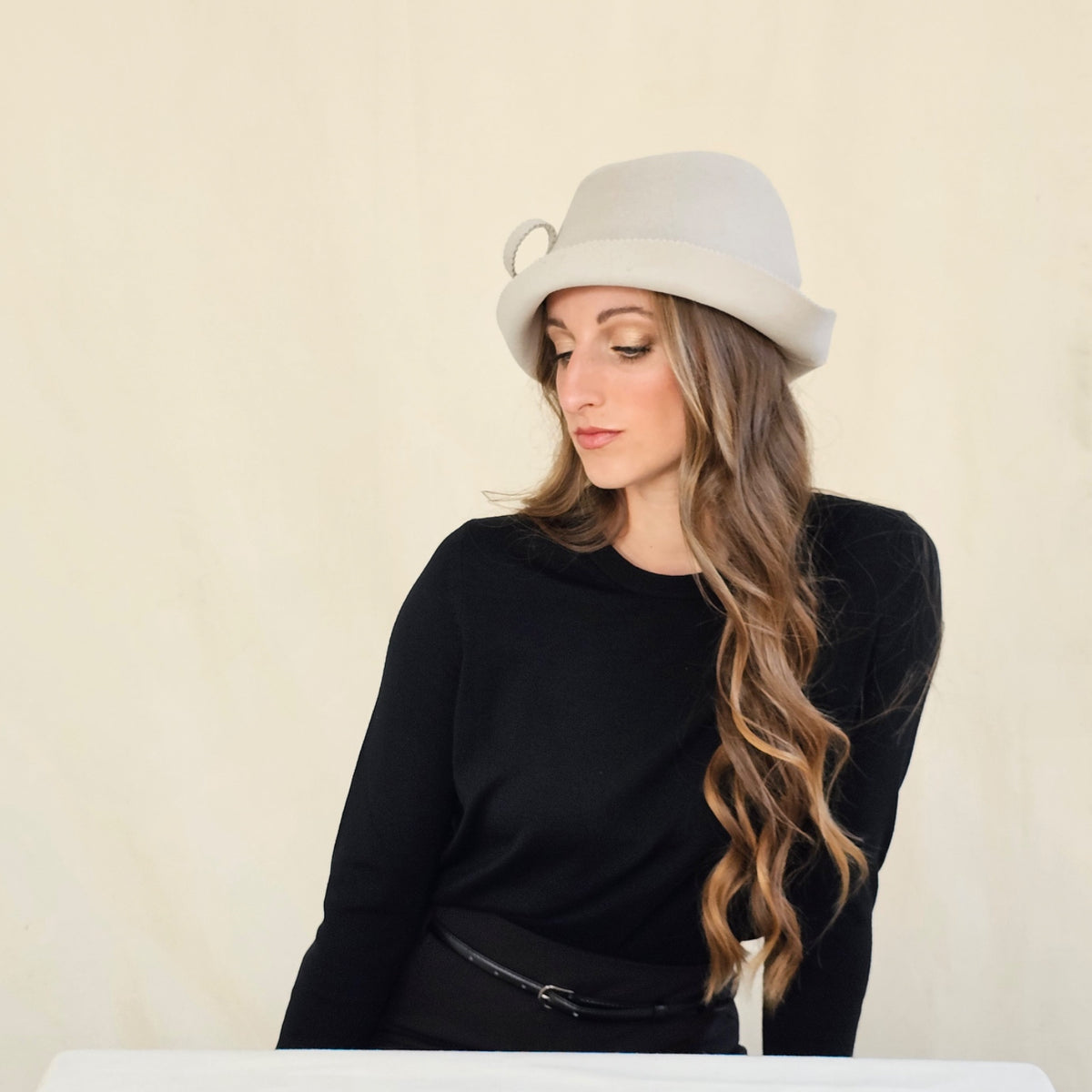 Angled view of stone felt trilby showing its shaped crown.