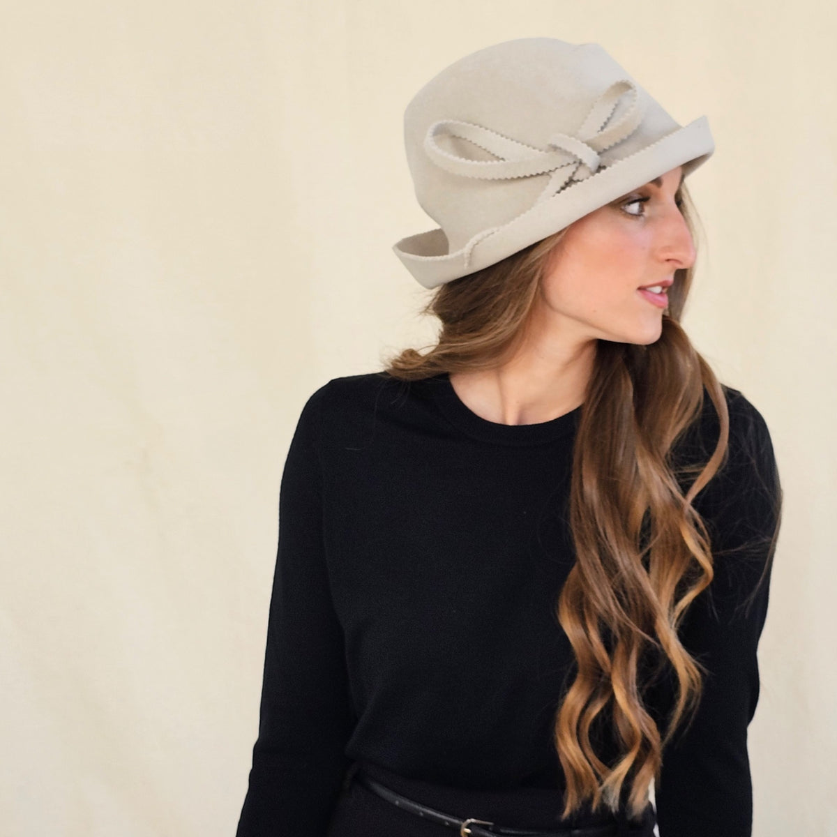 Side view of stone felt trilby showing layered loop bow and zigzag
edges