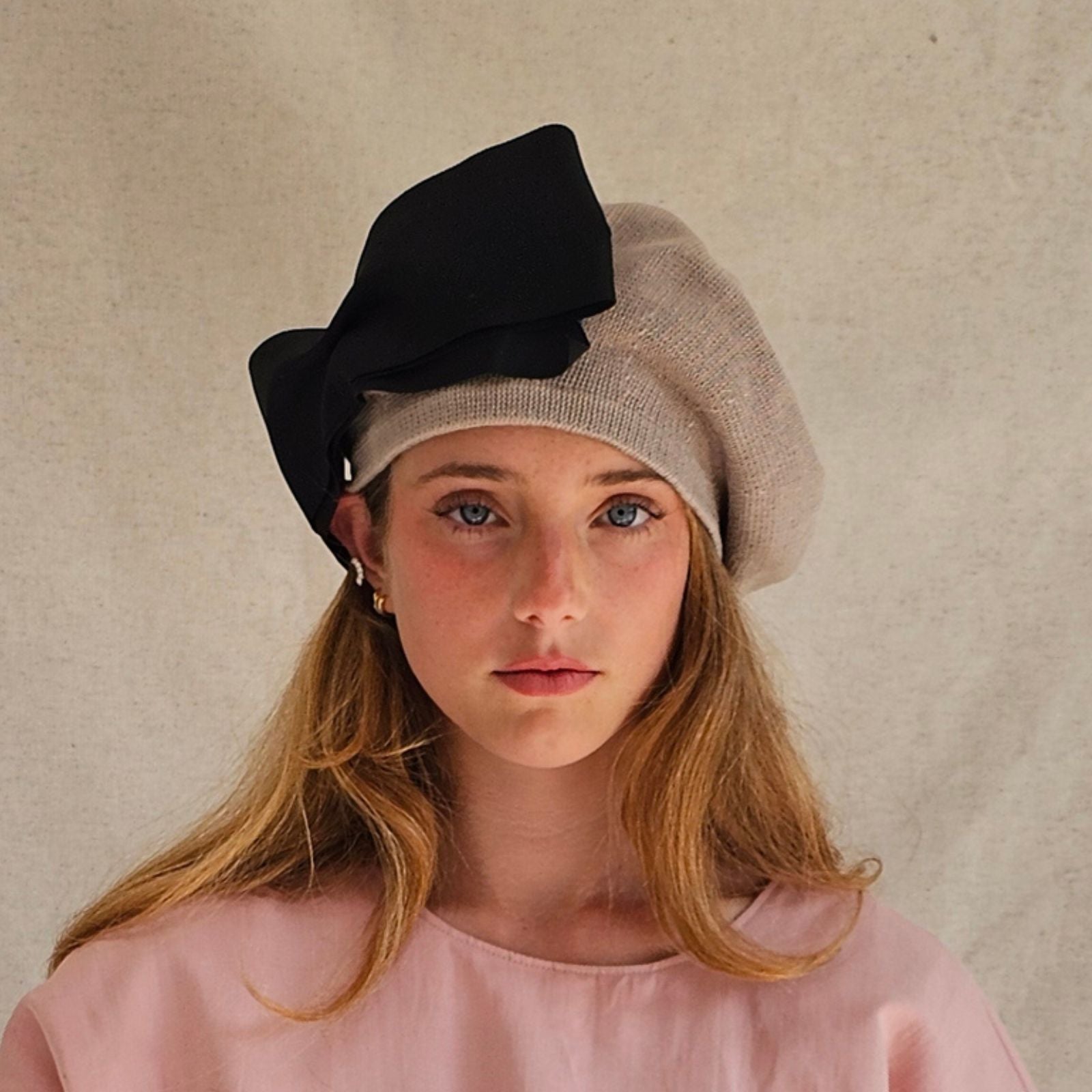 Taupe cotton beret with dramatic black bow, front view.