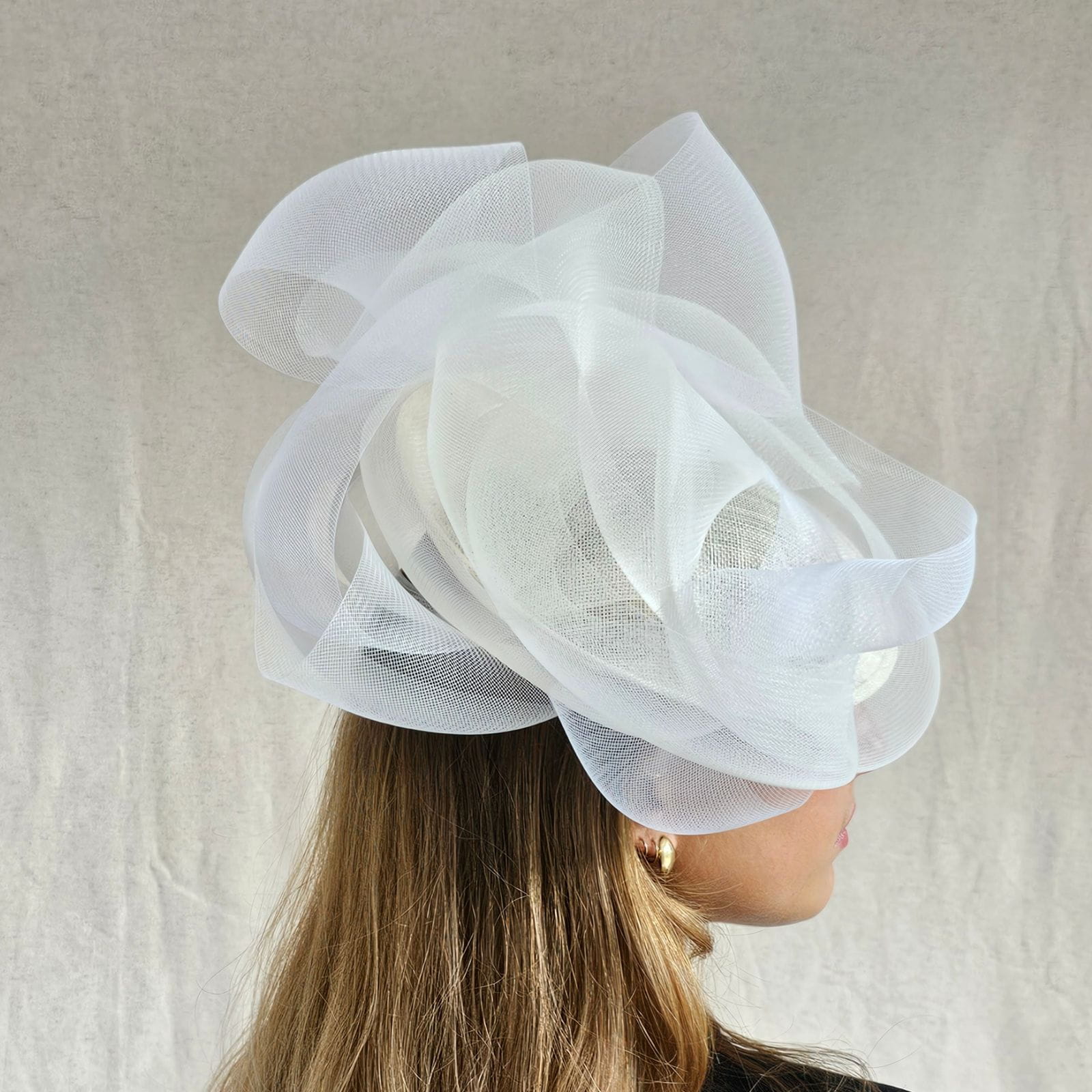 Ivory wedding disc hat with elegant crin swirls, side view.