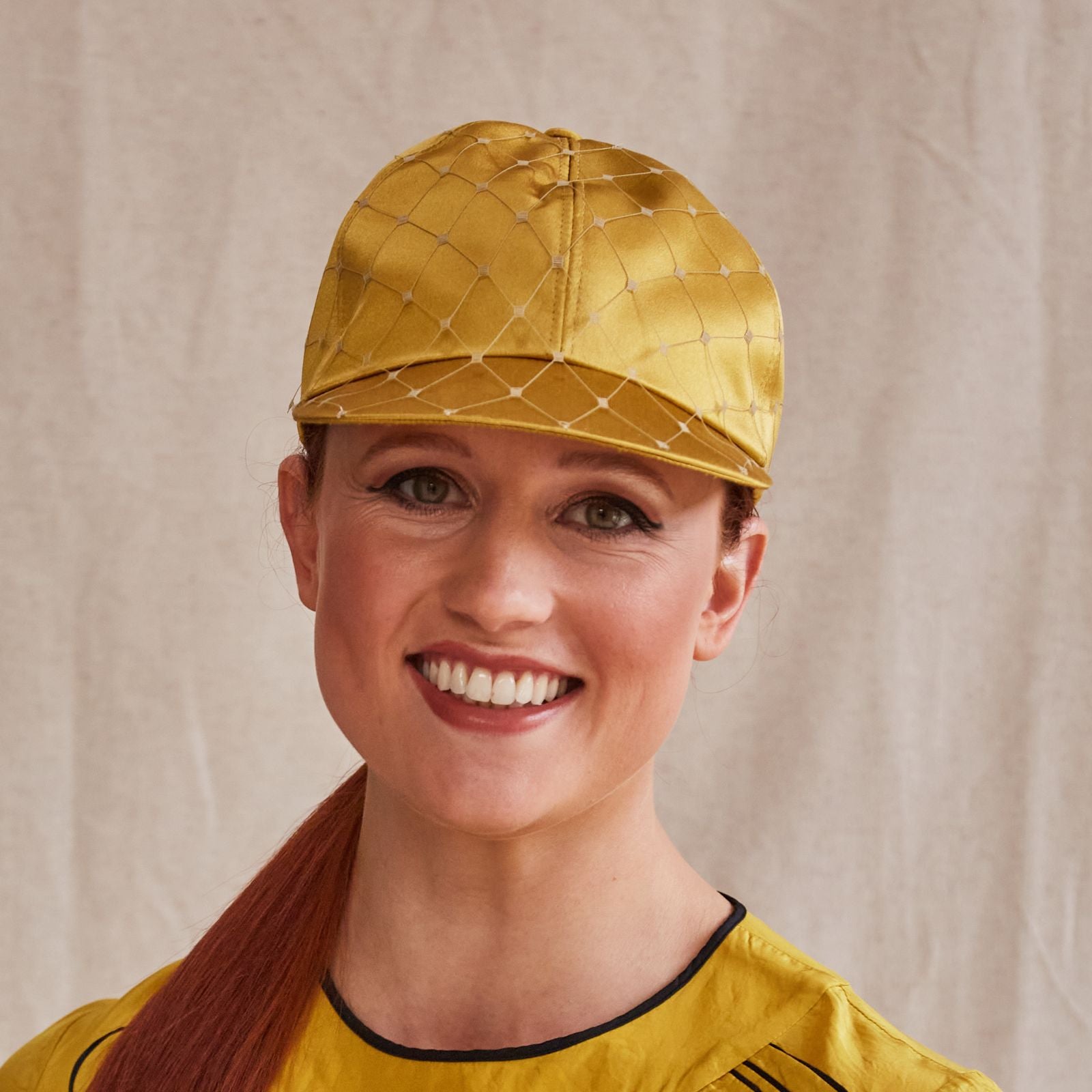 Yellow silk baseball cap with subtle veiling, front view.