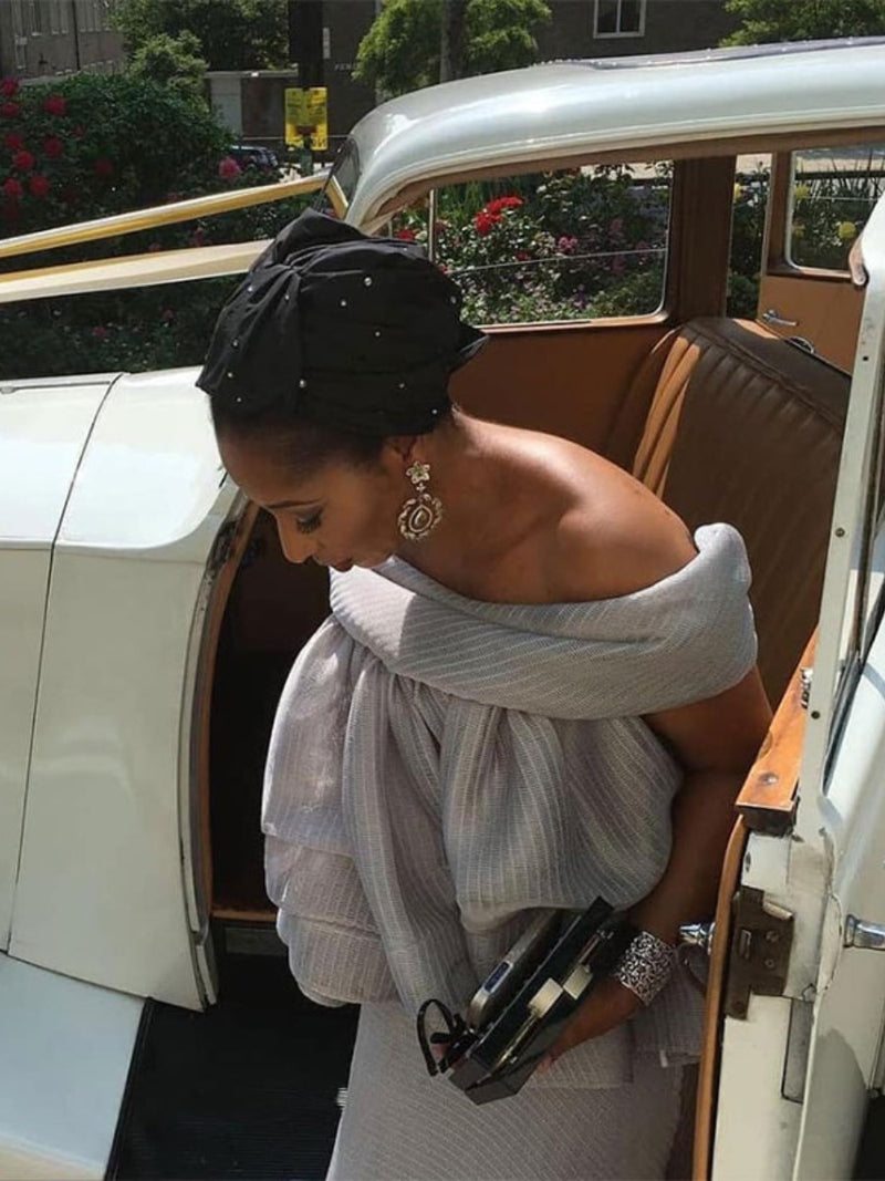 Angela  Ndidi Anyaehie owner of Designers Club Lagos wears a black silk turban with crystal embellishments  by London milliner Nerida Fraiman.