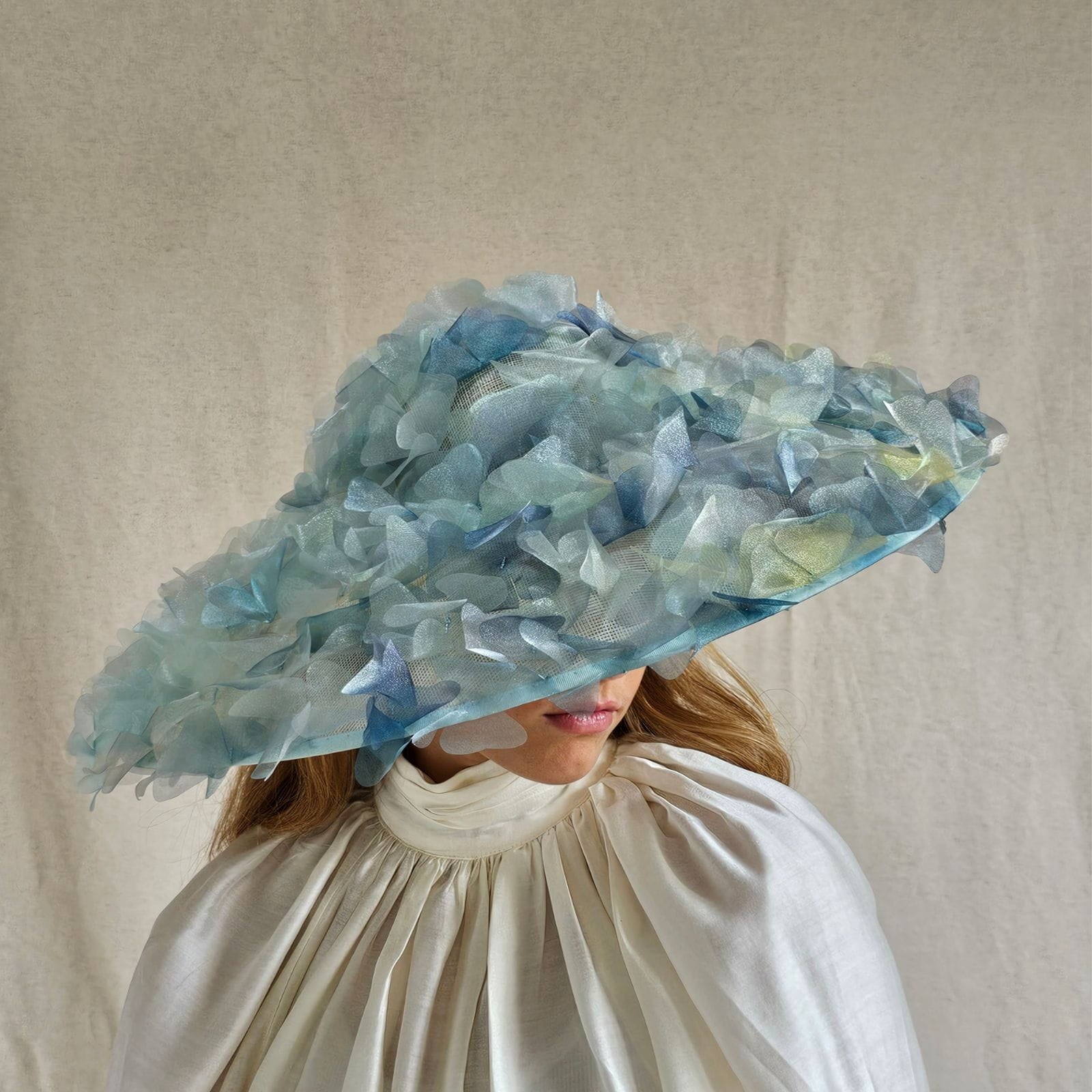 Ascot aqua and organza pictura hat with beautiful flowers, angle view.