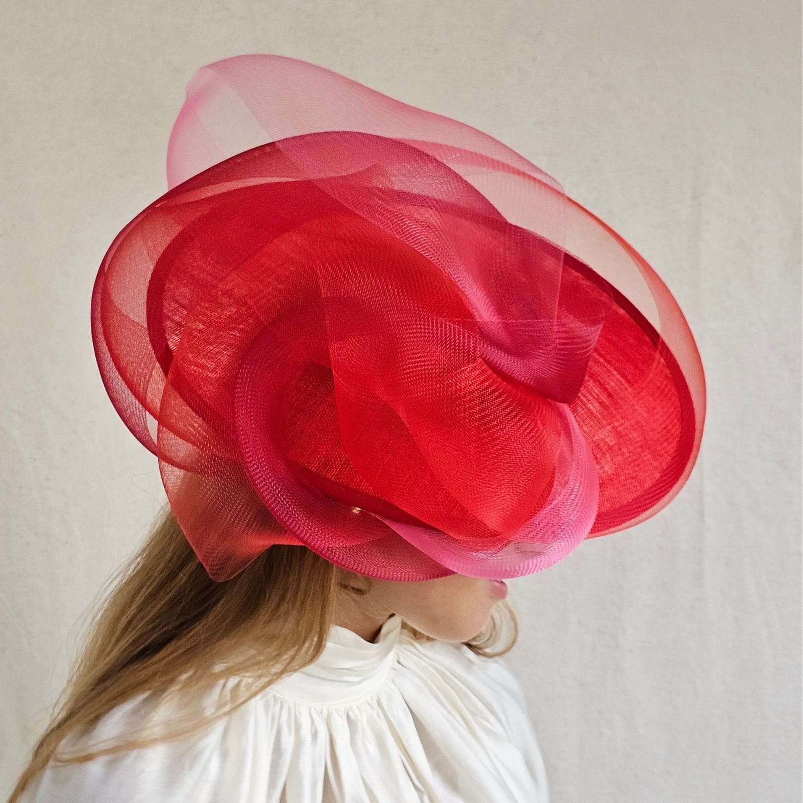 Red ascot disc hat with beautiful crin swirls, sidetilt view.