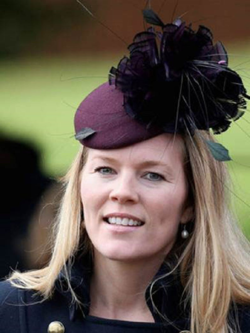 Autumn Phillips wearing a burgundy felt  and feather Nerida Fraiman beret  at Sandringham.