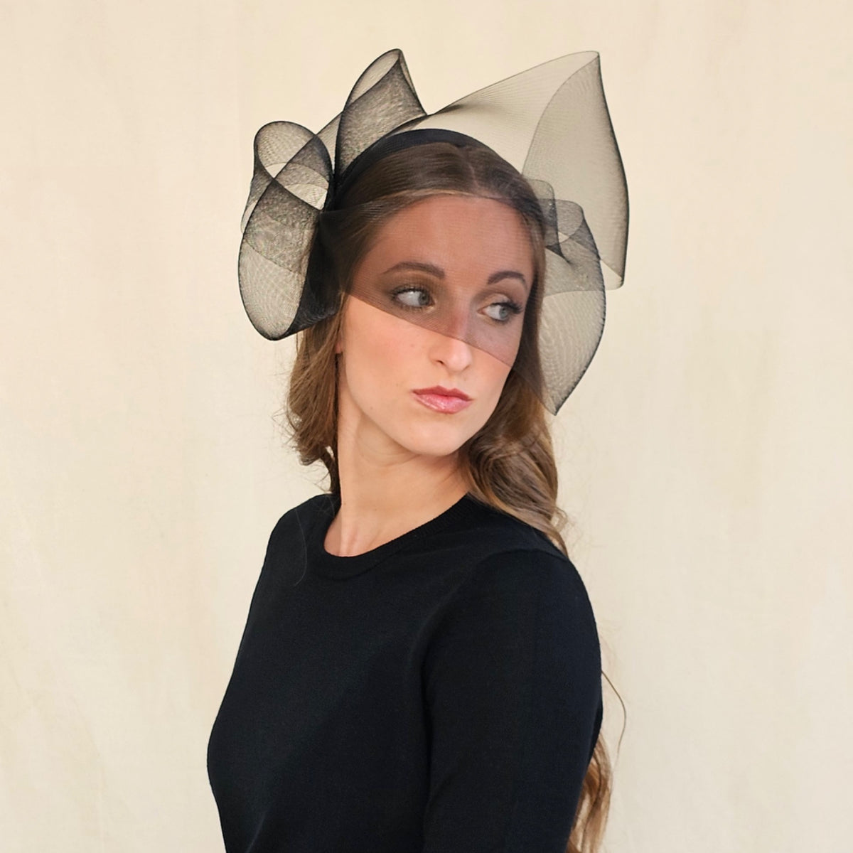 Black double-twist crin bow and face veil headband, worn on a
model.